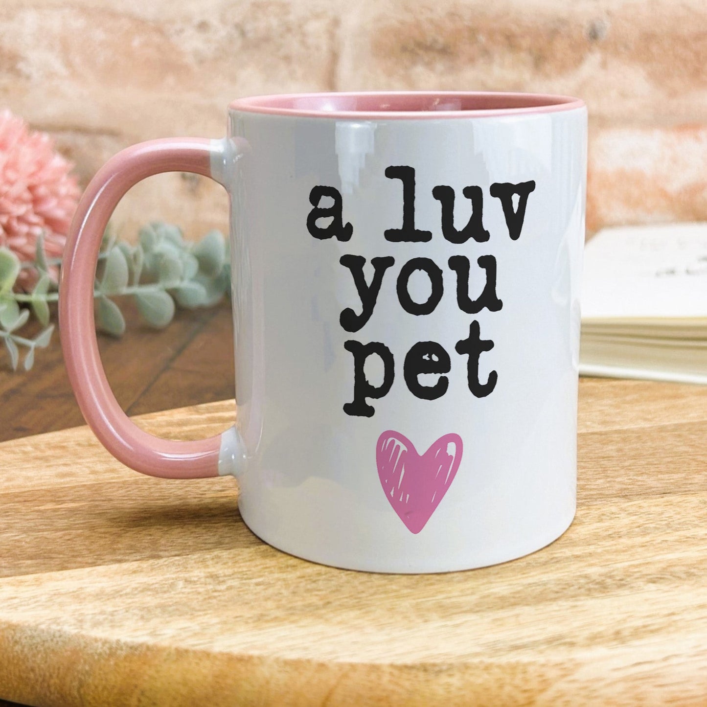 a pink and white coffee mug that says, a luv you pet
