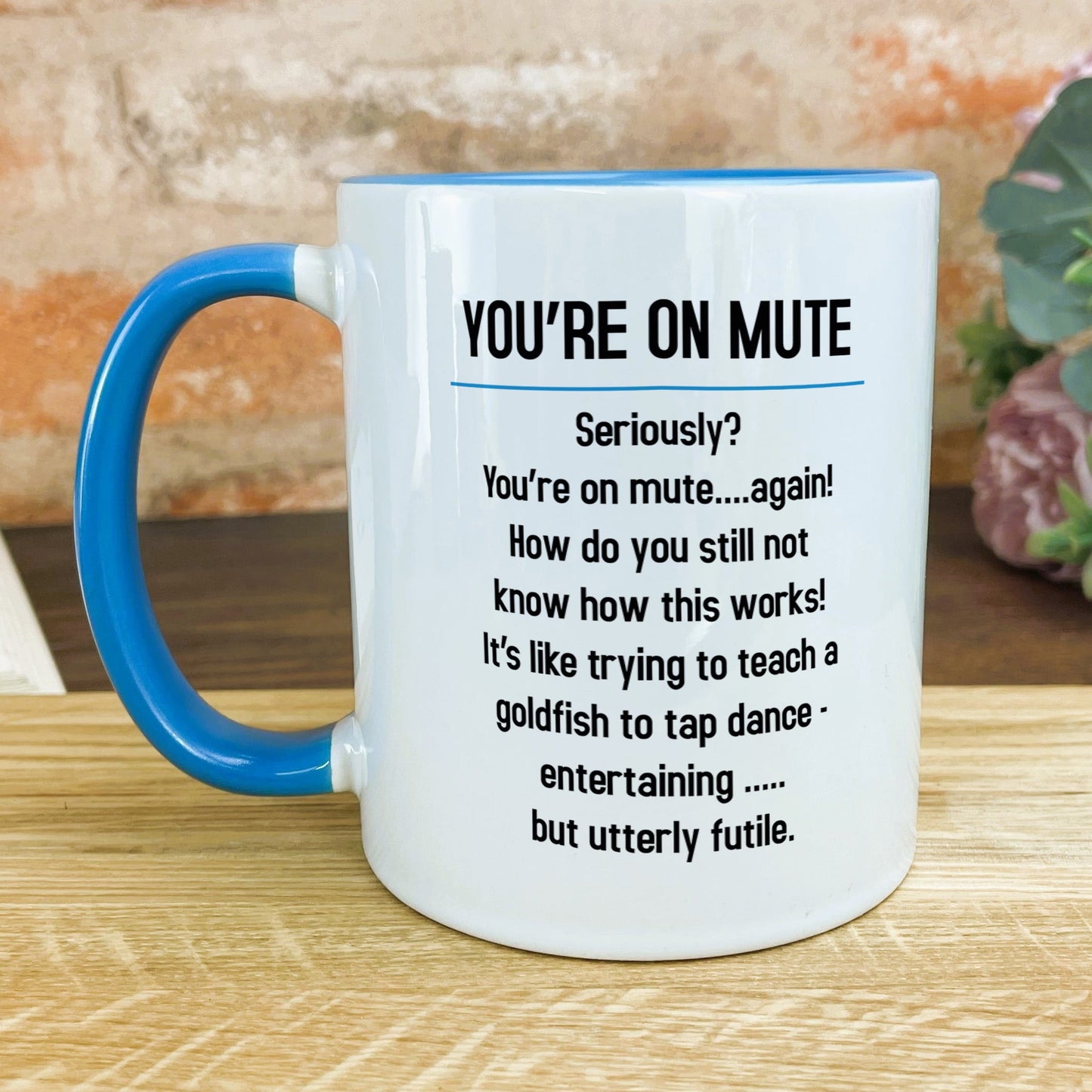 a blue and white coffee mug sitting on top of a wooden table