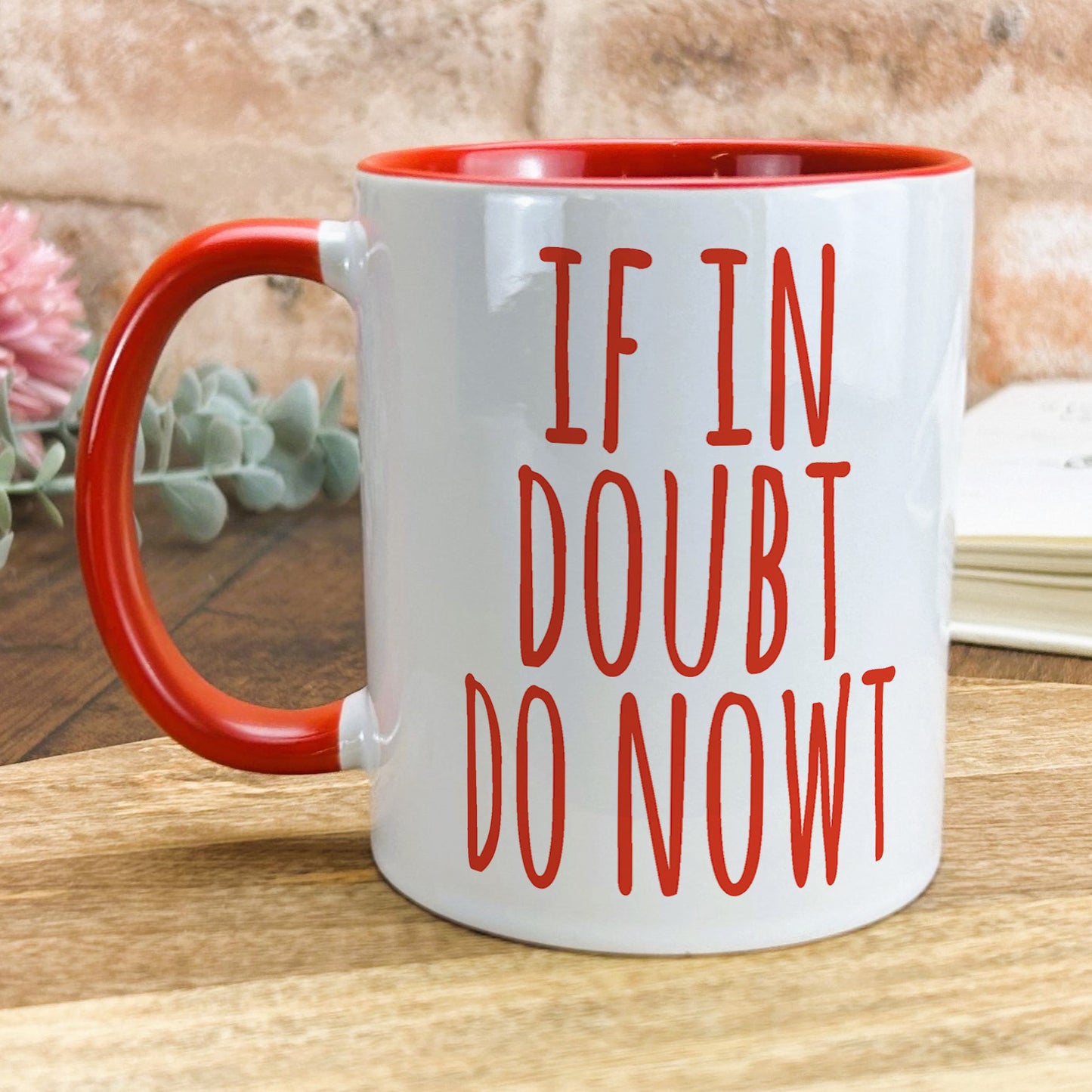 a red and white coffee mug that says if in doubt do now