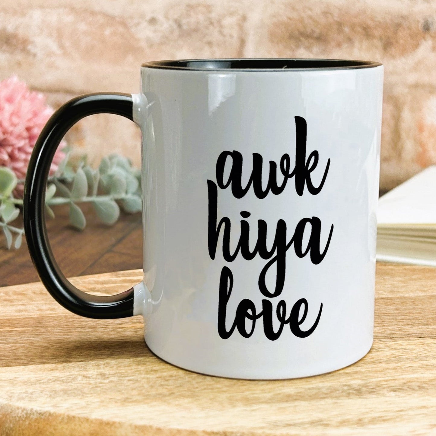 a black and white coffee mug sitting on a wooden table