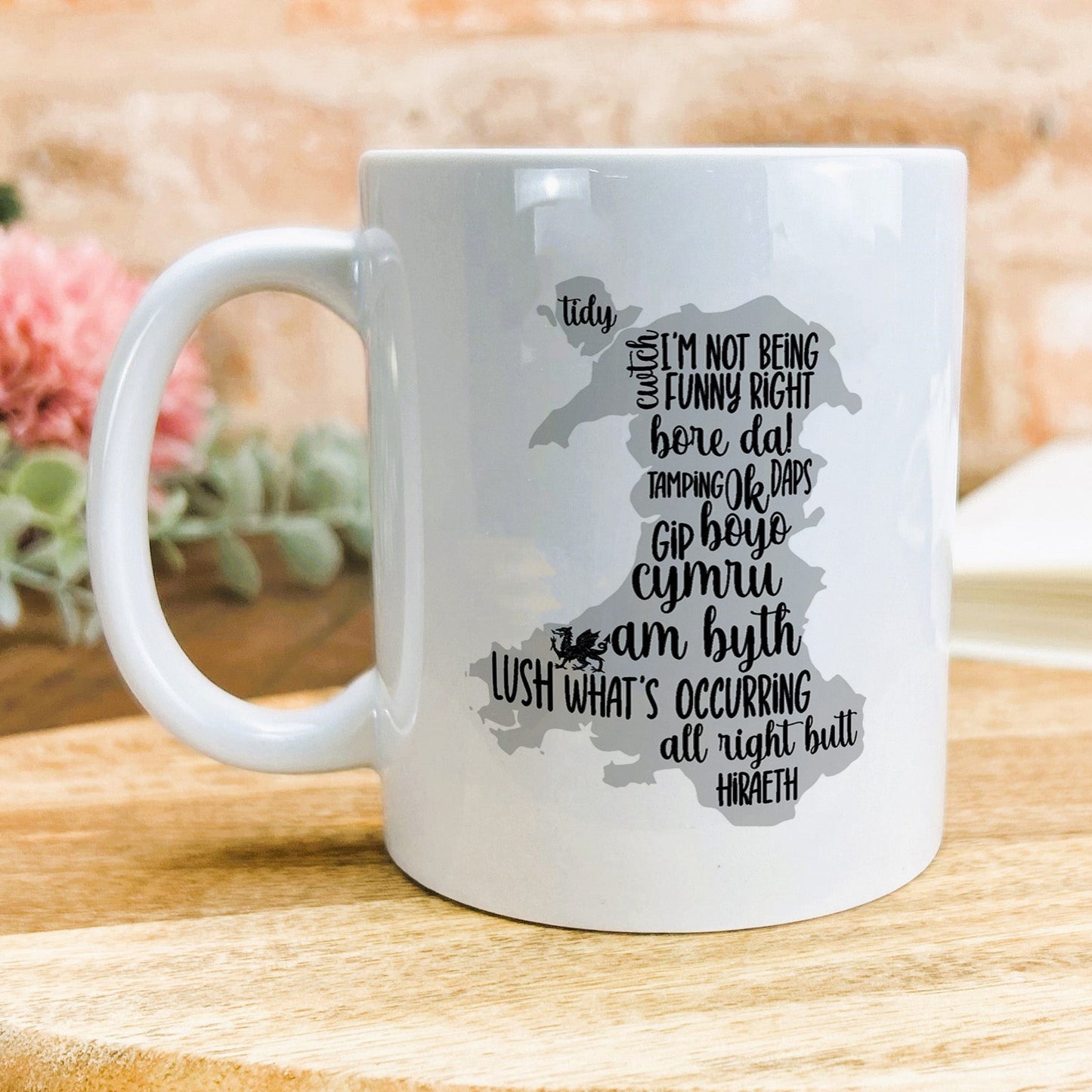 a white coffee mug sitting on top of a wooden table