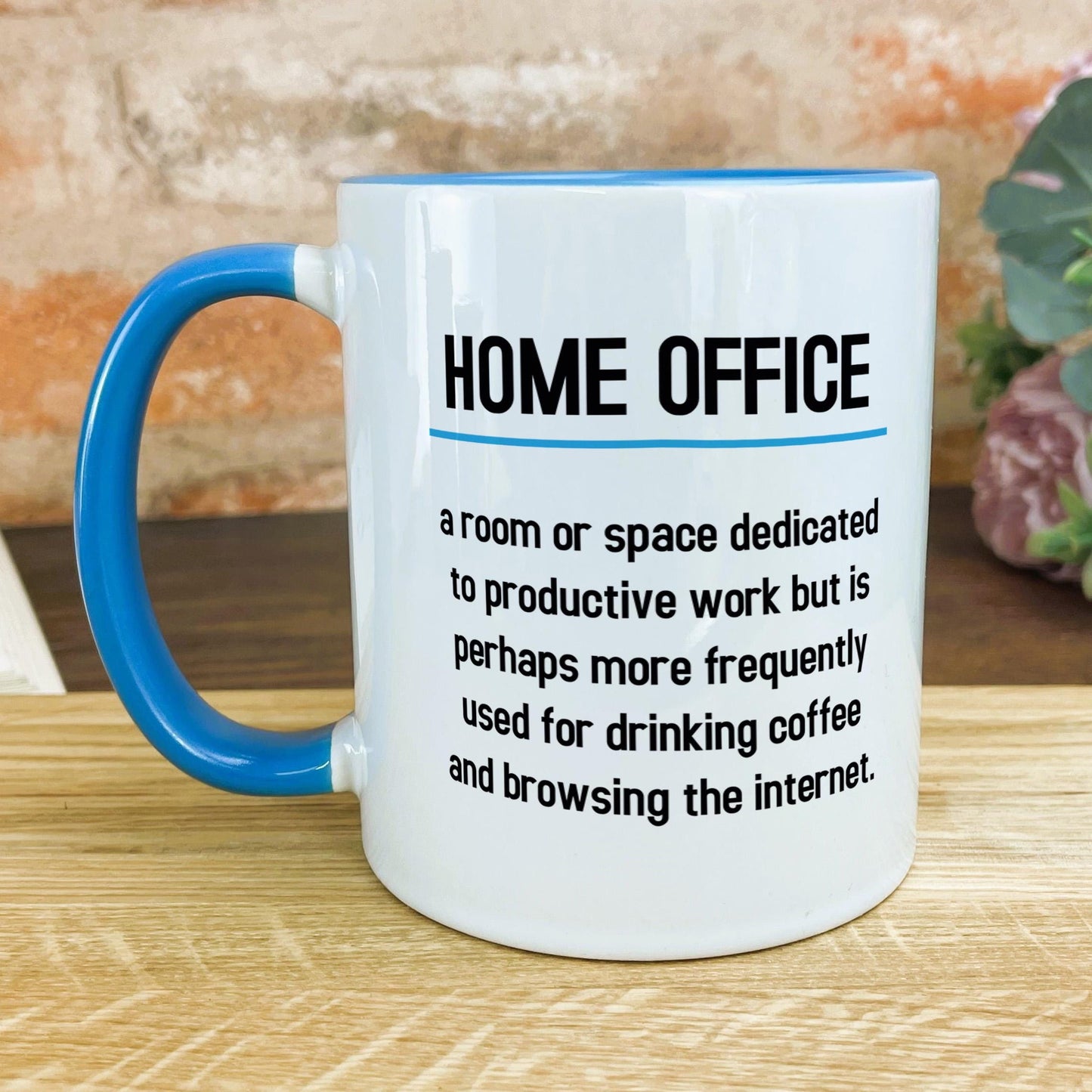 a blue and white coffee mug sitting on top of a wooden table