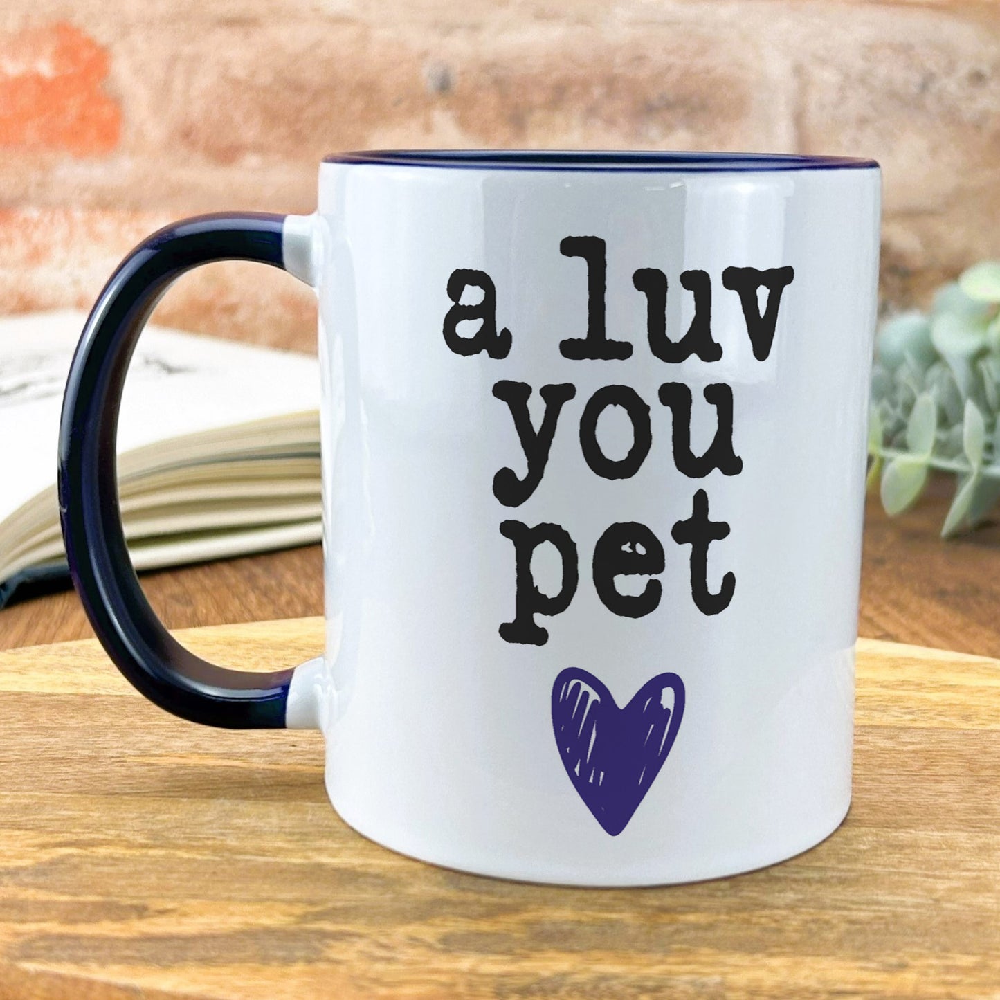 a blue and white coffee mug with a purple heart on it