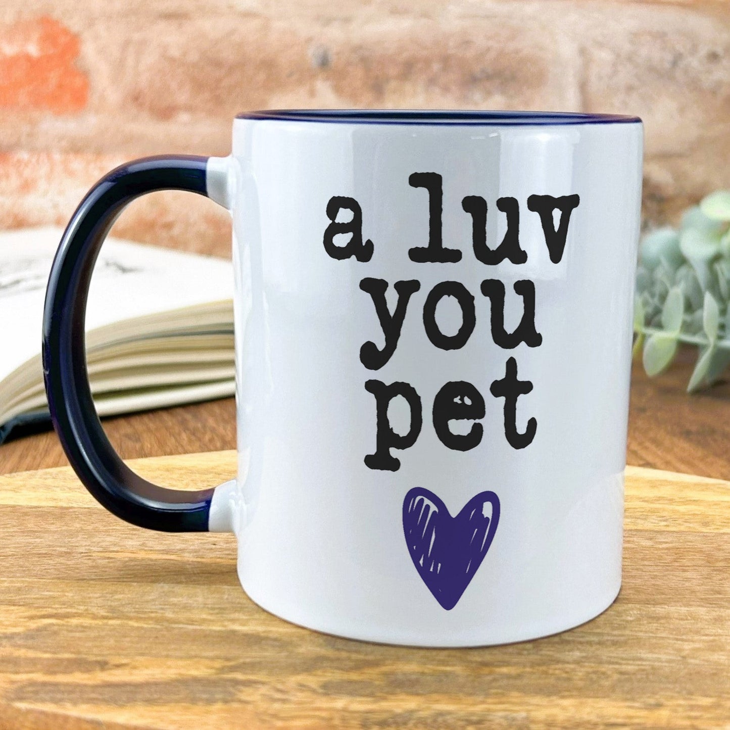 a blue and white coffee mug with a purple heart on it