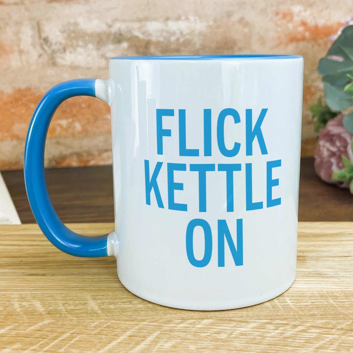 a blue and white coffee mug sitting on top of a wooden table