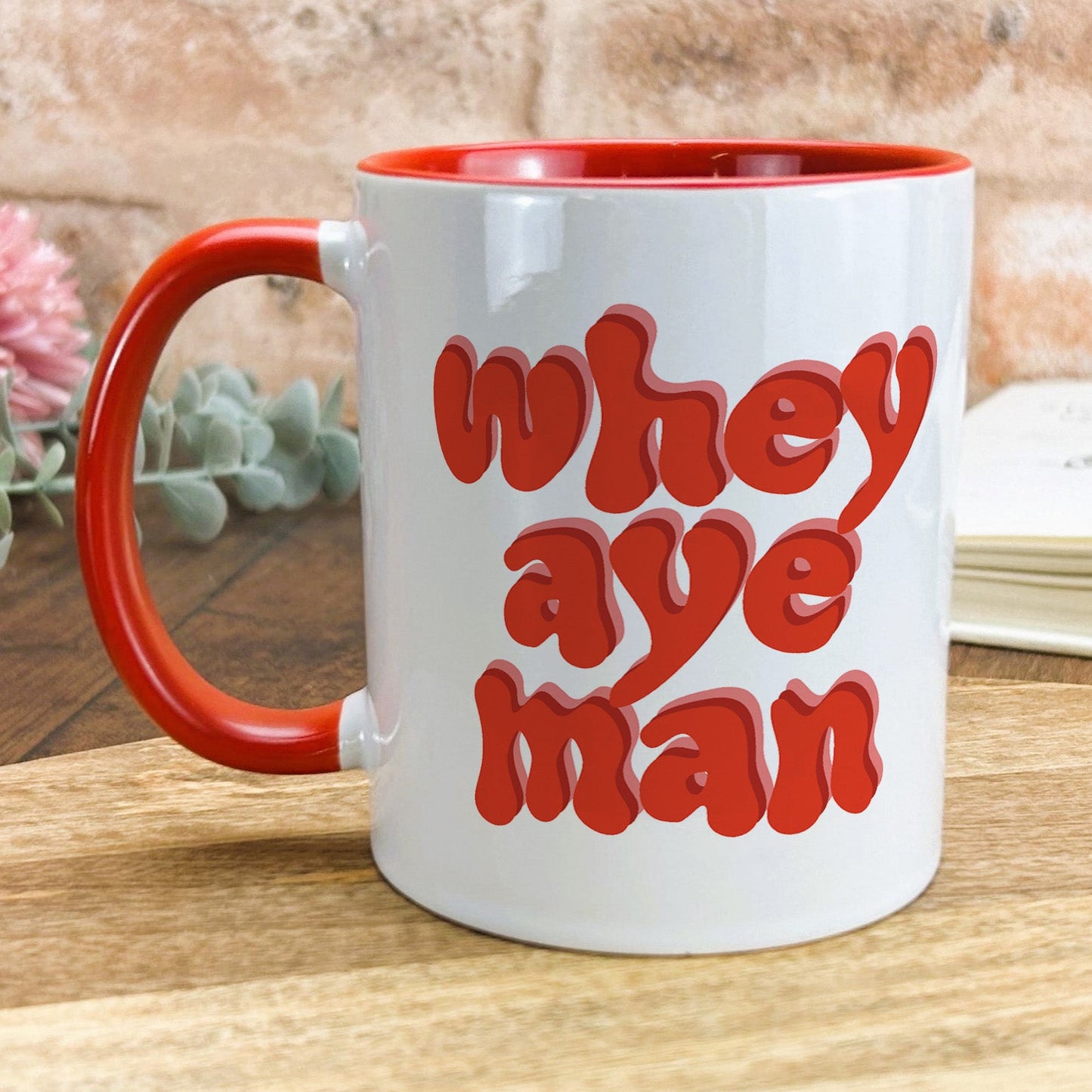 a red and white coffee mug with the words, they are man on it