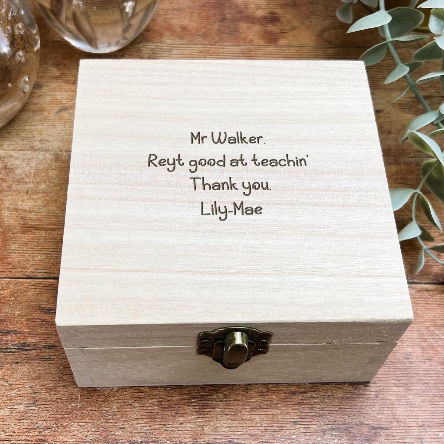 a wooden box sitting on top of a wooden table