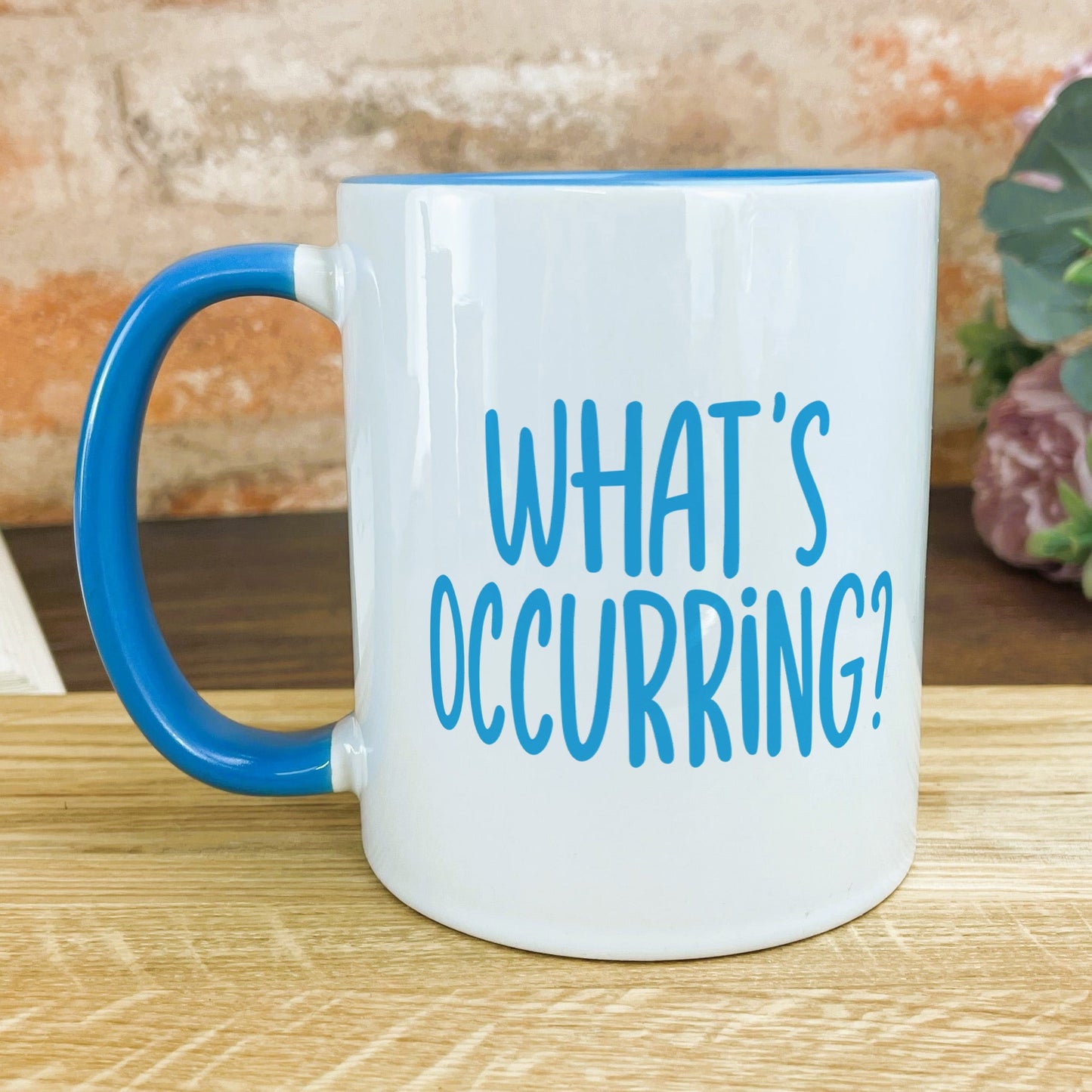 a blue and white coffee mug sitting on a table