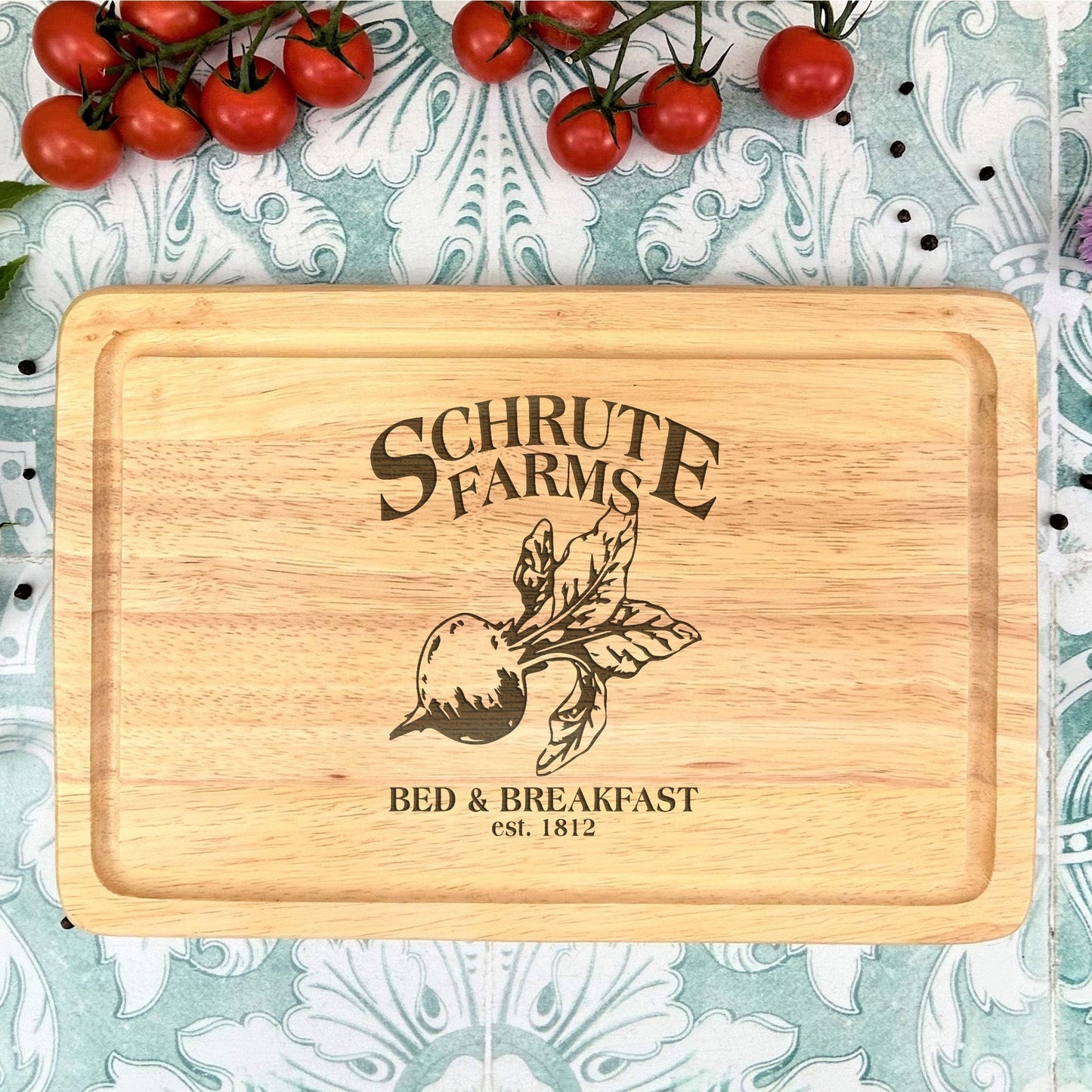 a cutting board with a picture of a tomato on it
