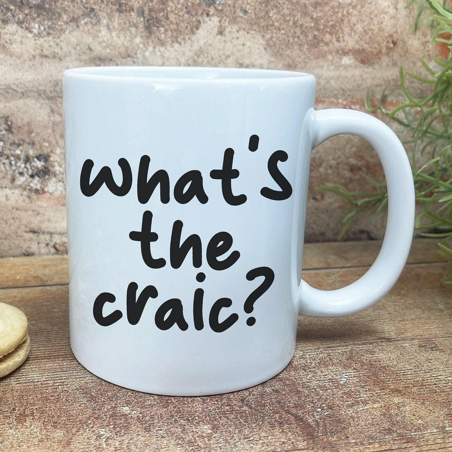 A white ceramic mug with the text "what's the craic?" printed on it.