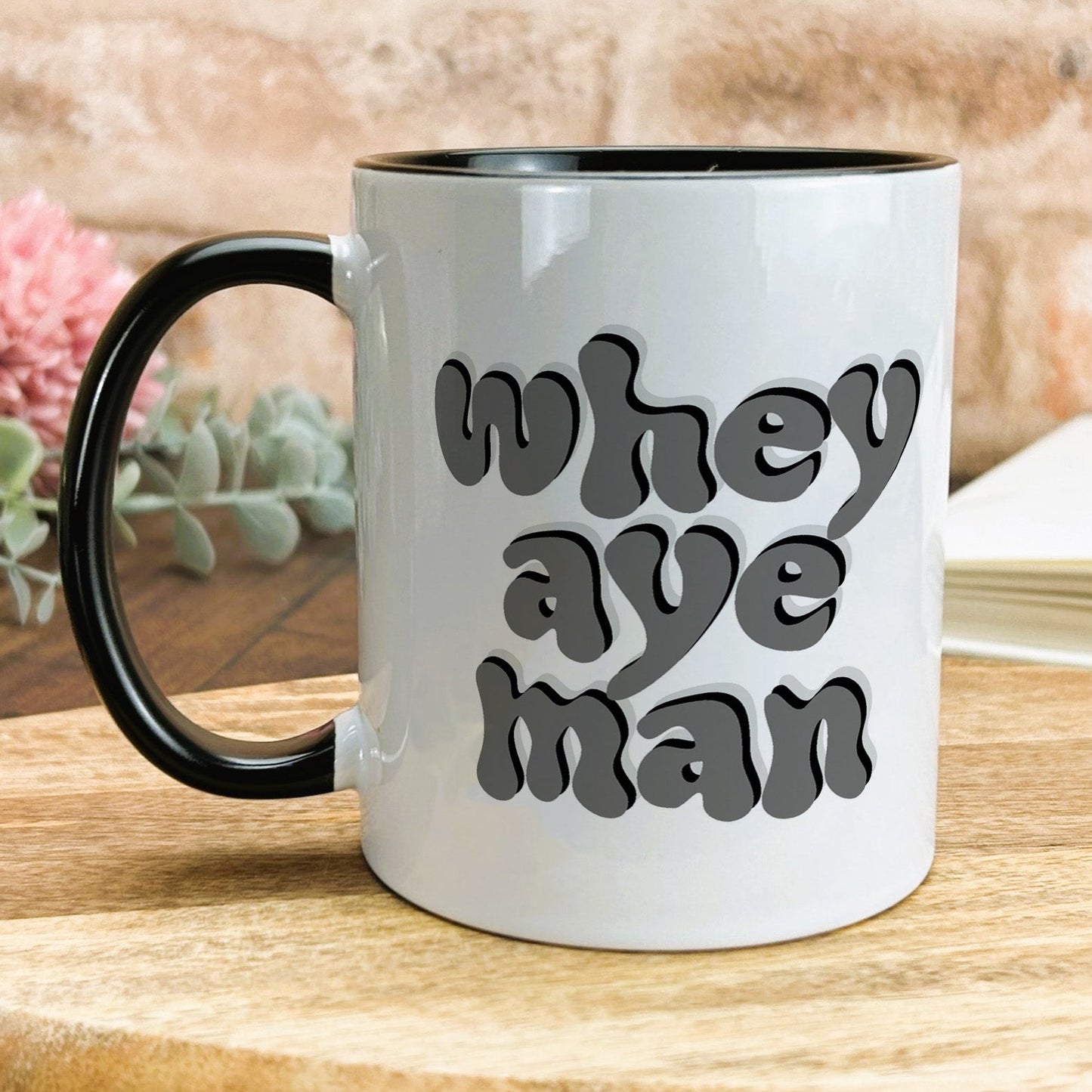 a black and white coffee mug with the words when we're man on it