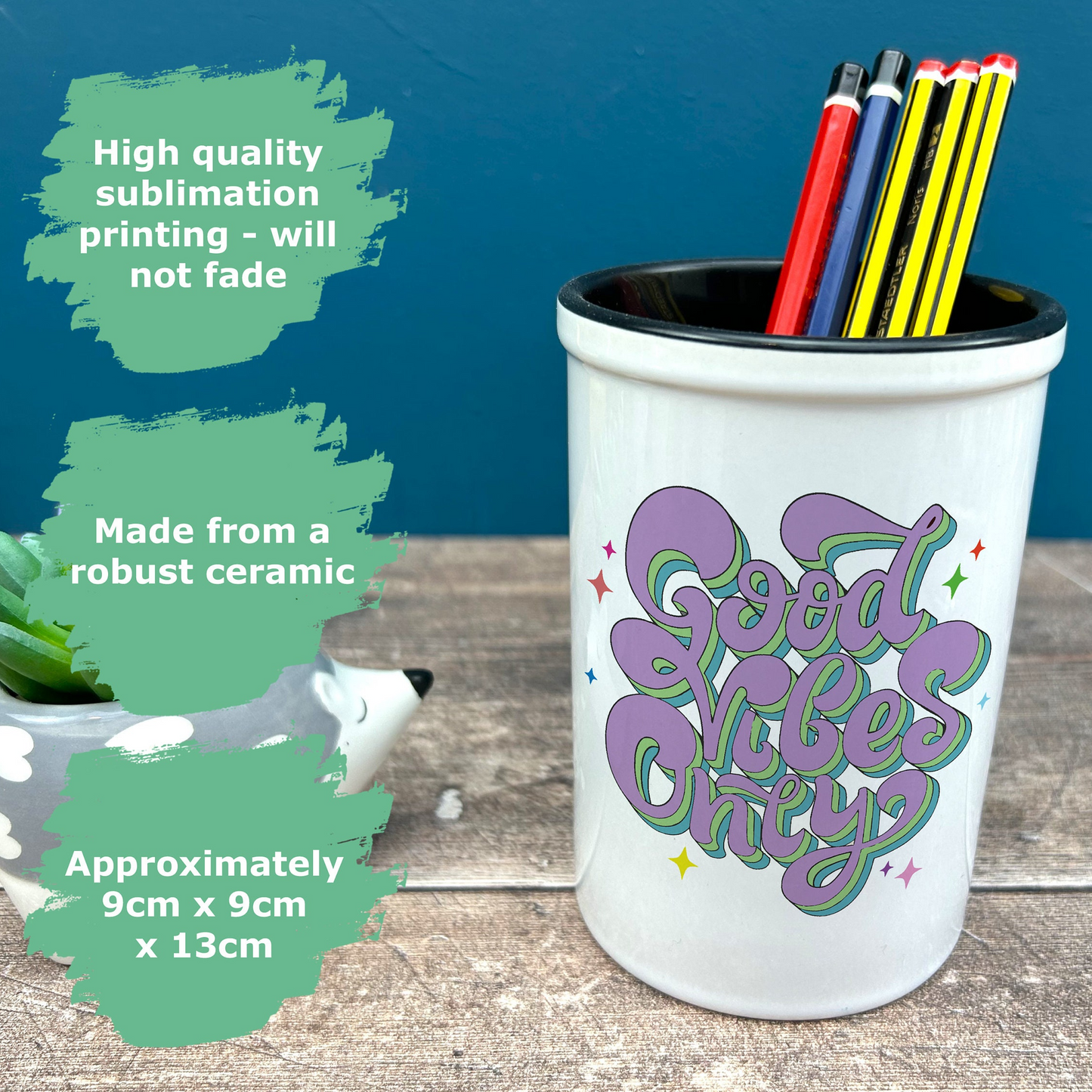 a cup with some pencils and markers in it