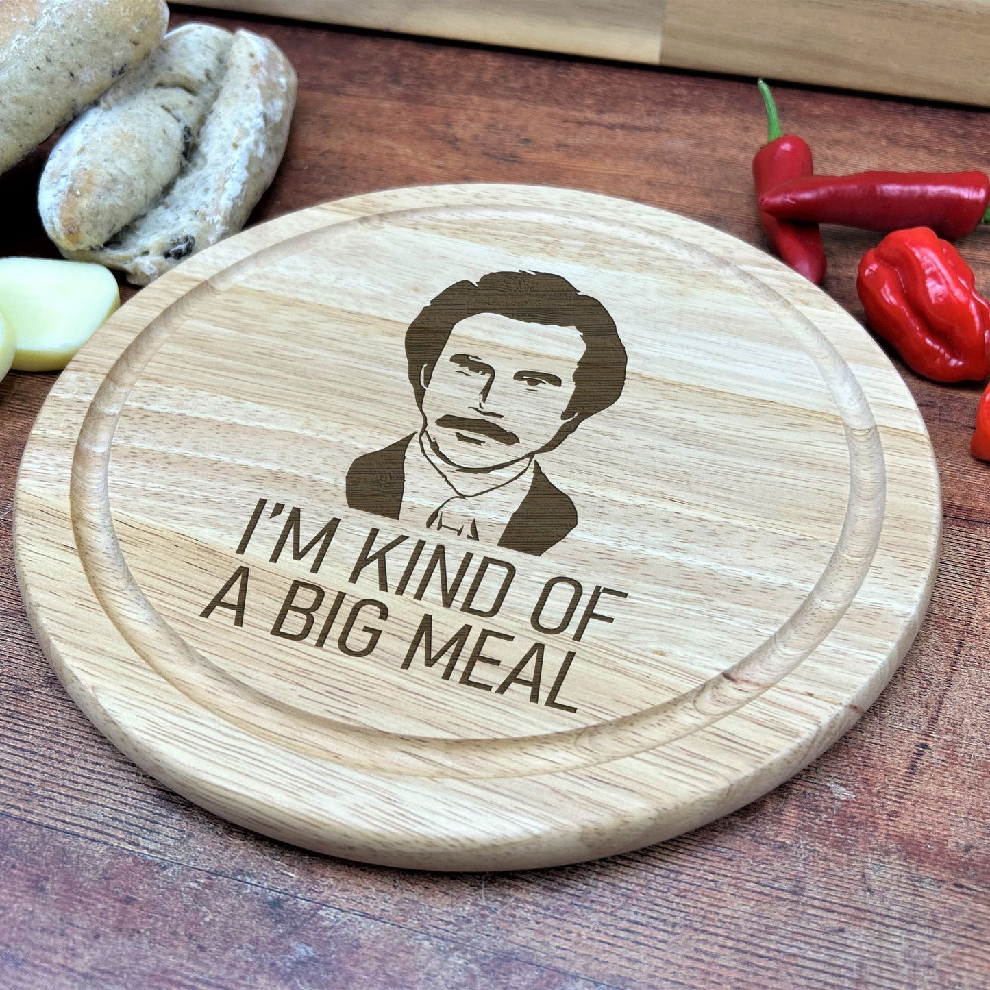 a wooden cutting board with a picture of a man on it