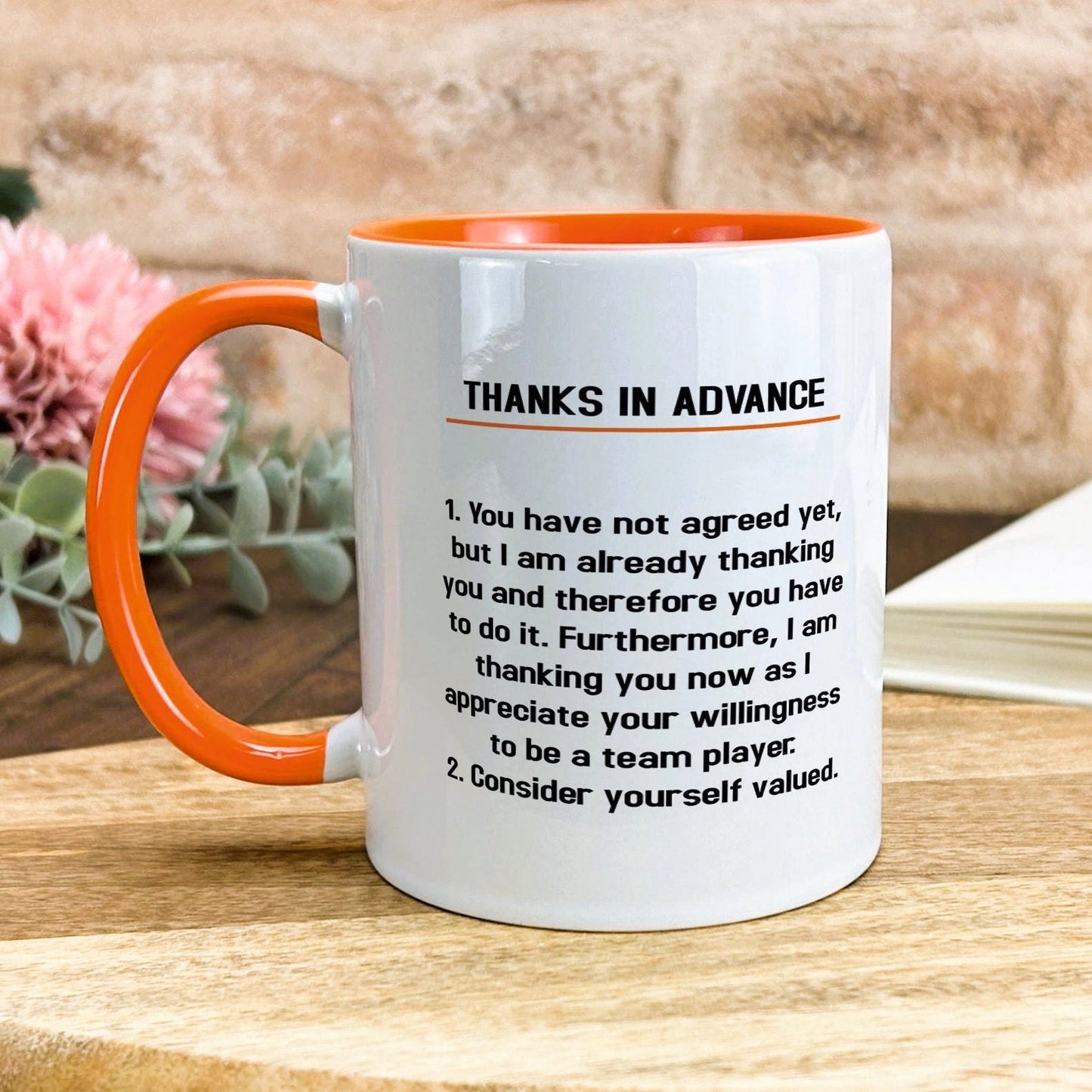 a white and orange coffee mug with a poem on it