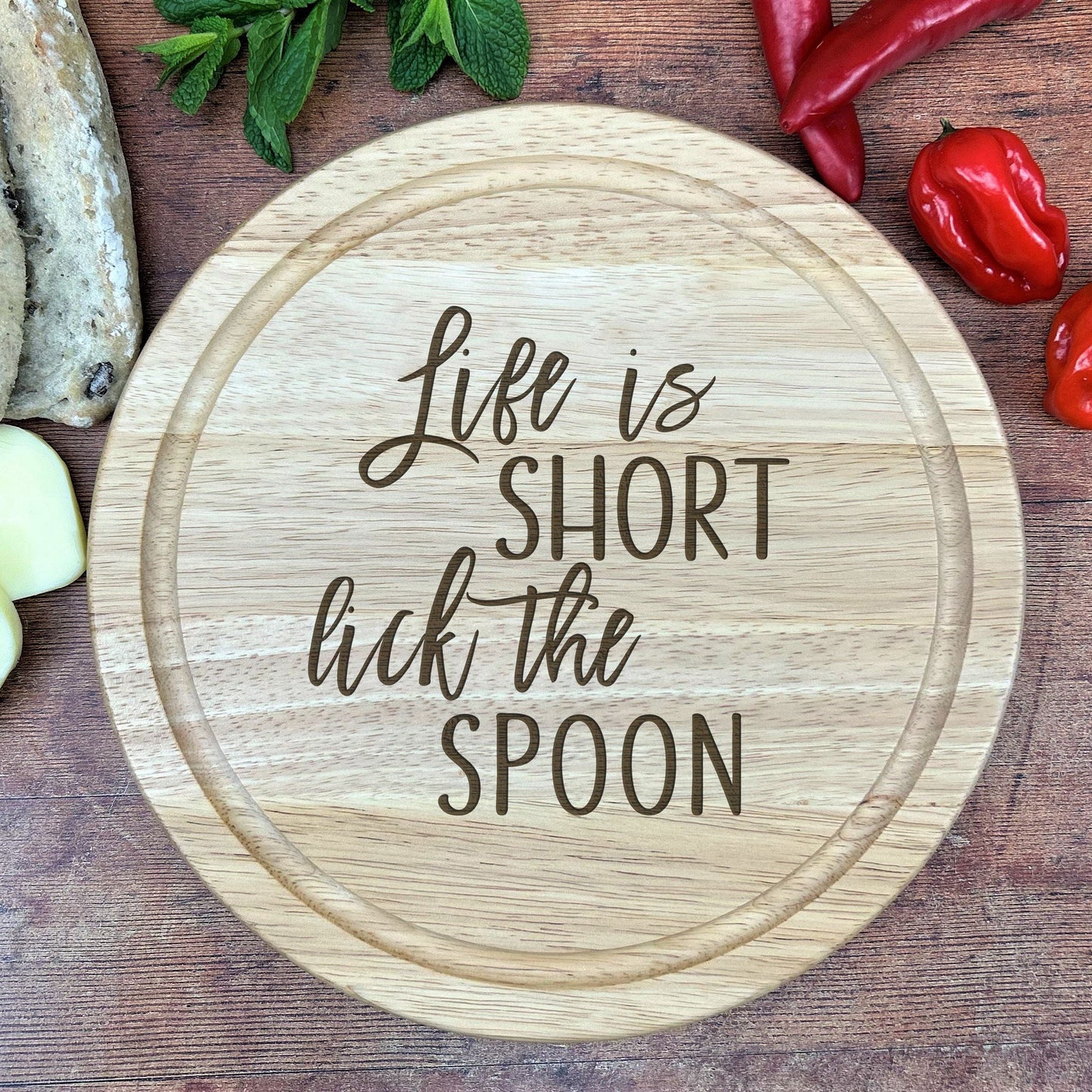 a wooden cutting board with a quote on it