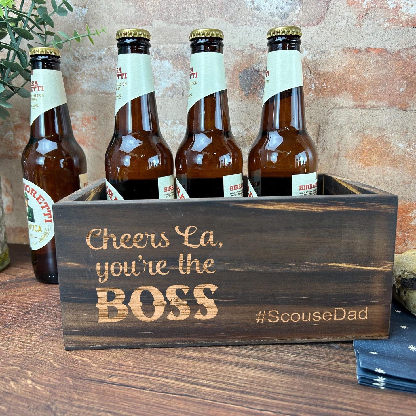 a wooden box with six bottles of beer in it