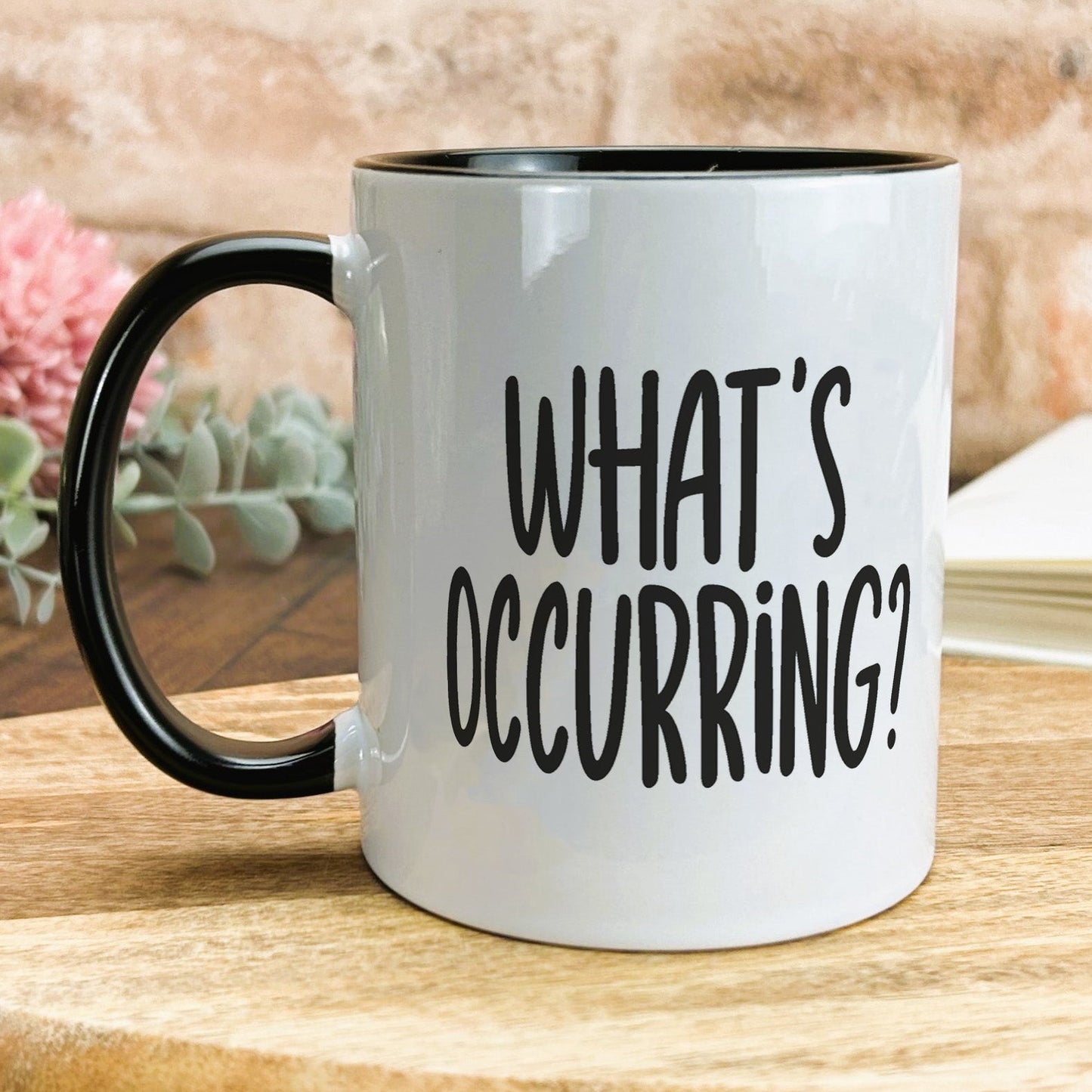 a black and white coffee mug that says what's occurring?