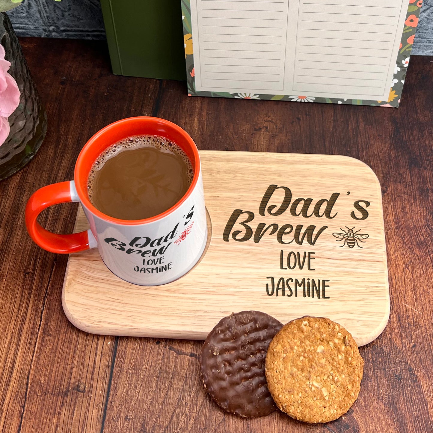 A wooden tray with a mug of coffee and two cookies, accompanied by a note that reads "Dad's Brew Love Jasmine".