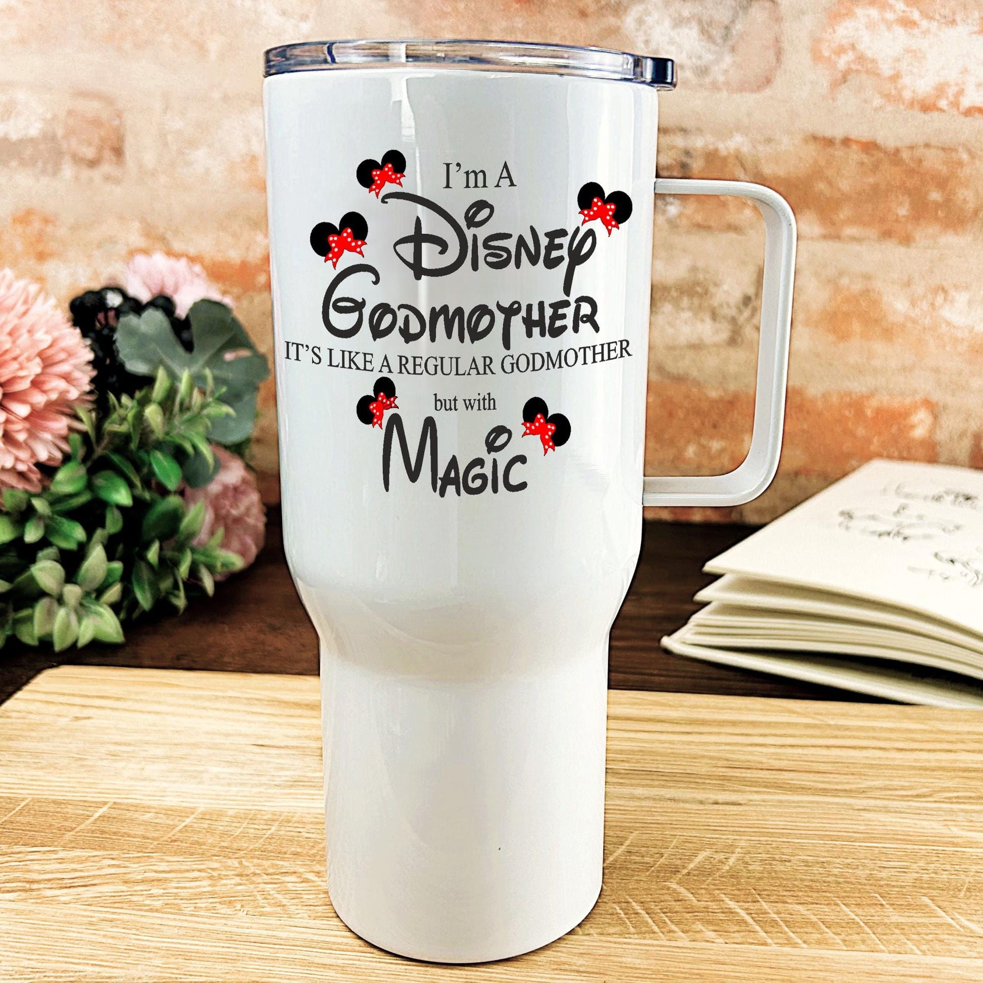 a white travel mug sitting on top of a wooden table