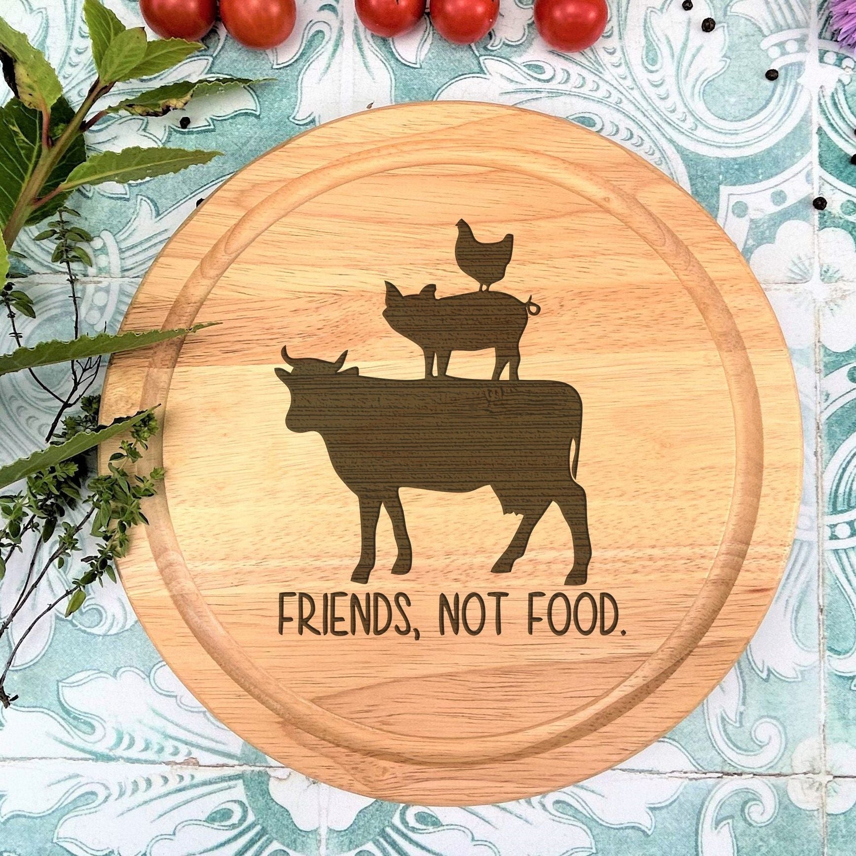a cutting board with a picture of a cow and two chickens on it