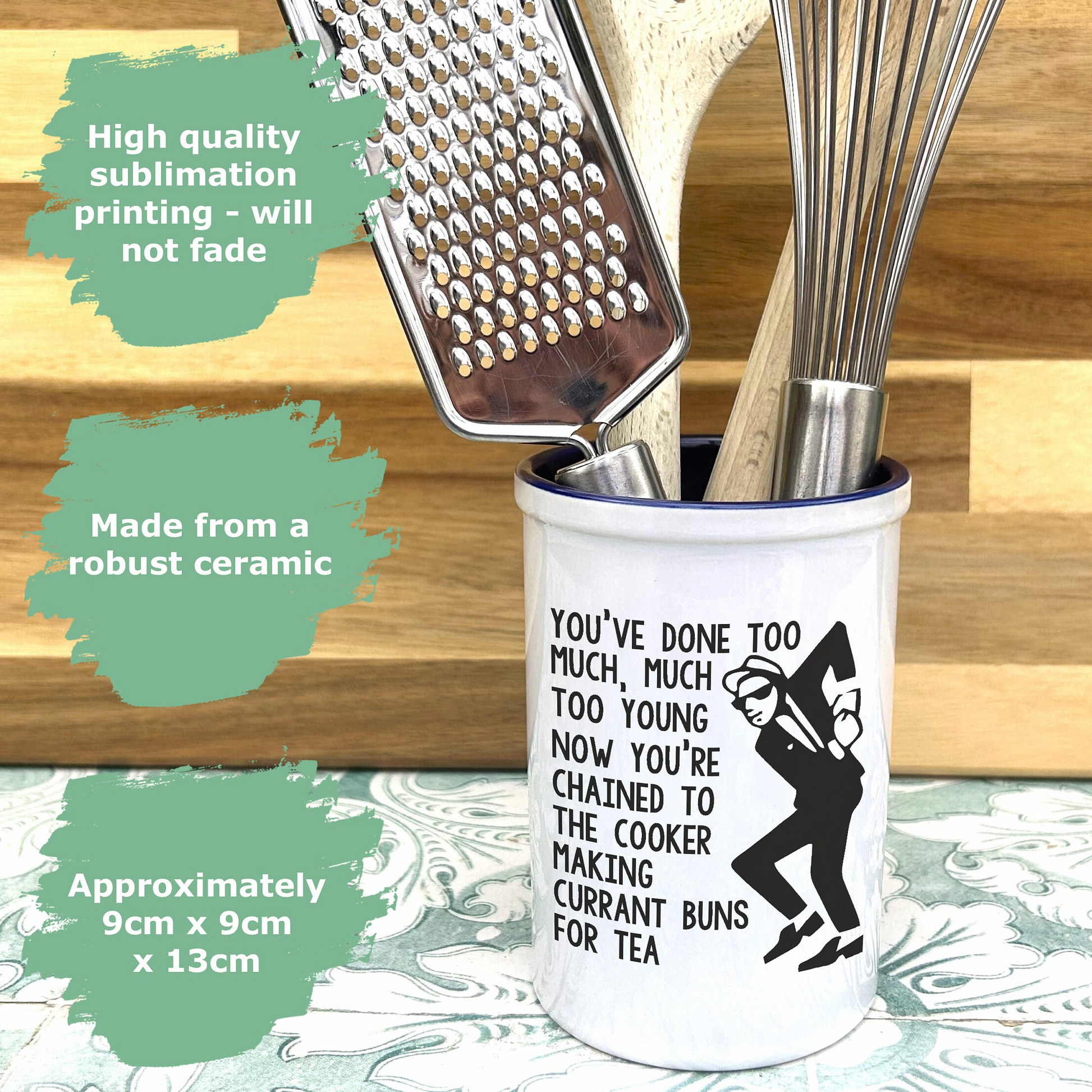 a cup that has some cooking utensils in it