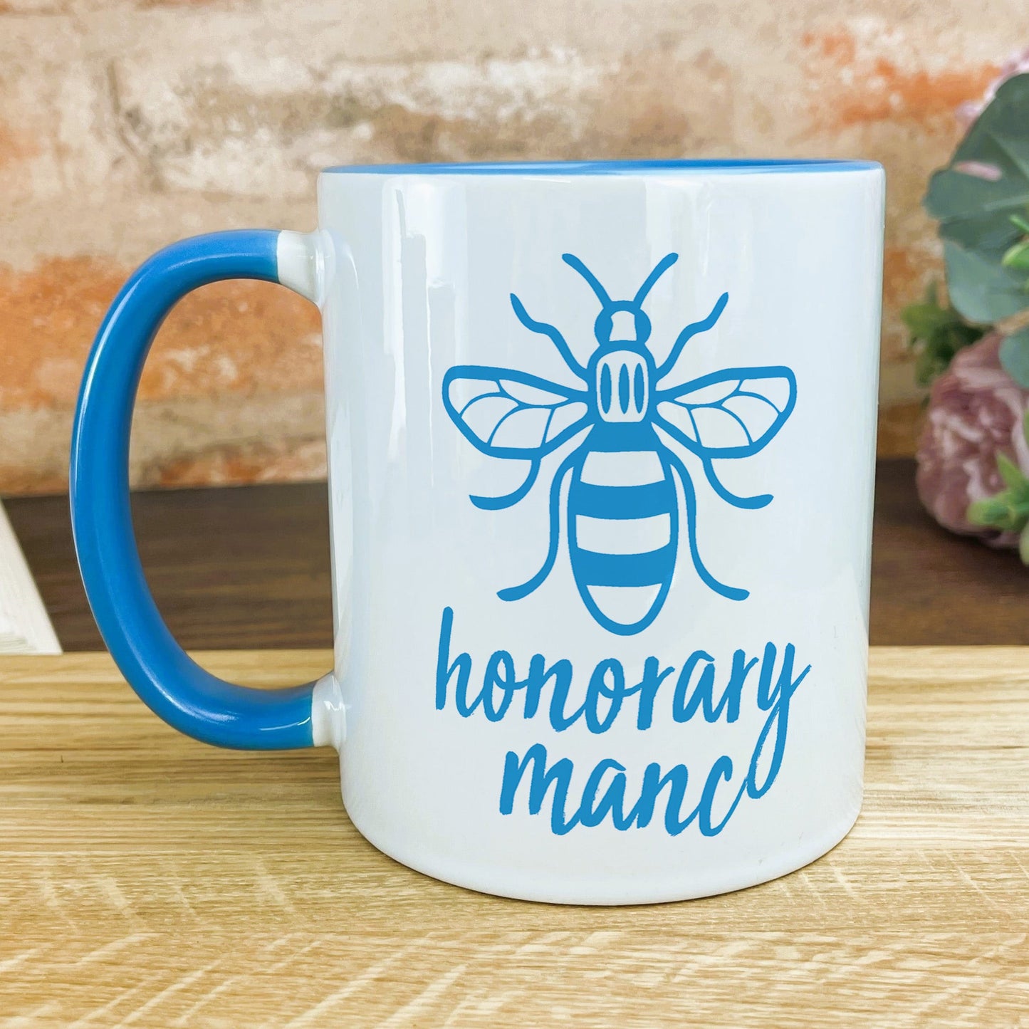 a blue and white coffee mug with a bee on it