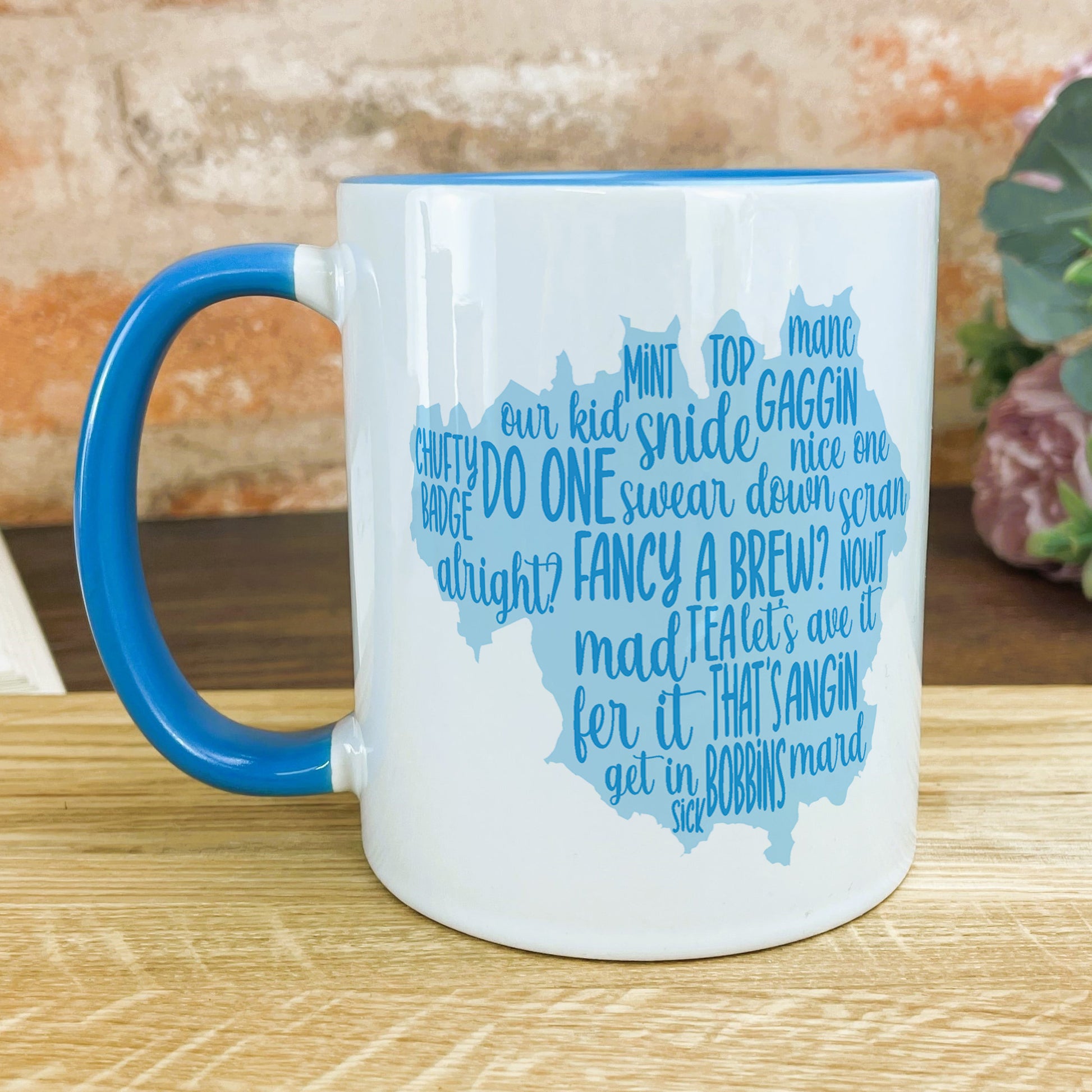 a blue and white mug sitting on top of a wooden table