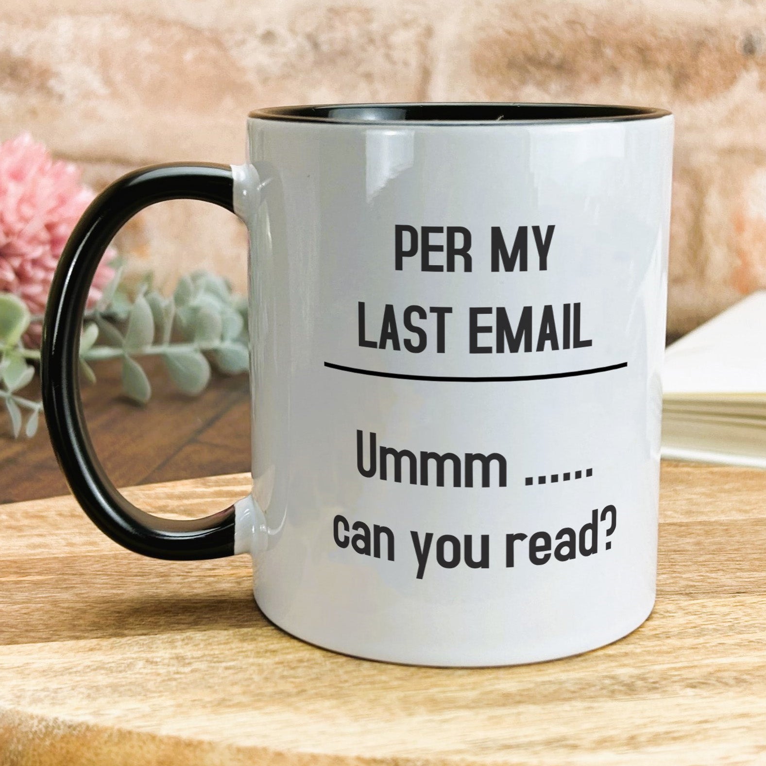 a black and white coffee mug on a wooden table