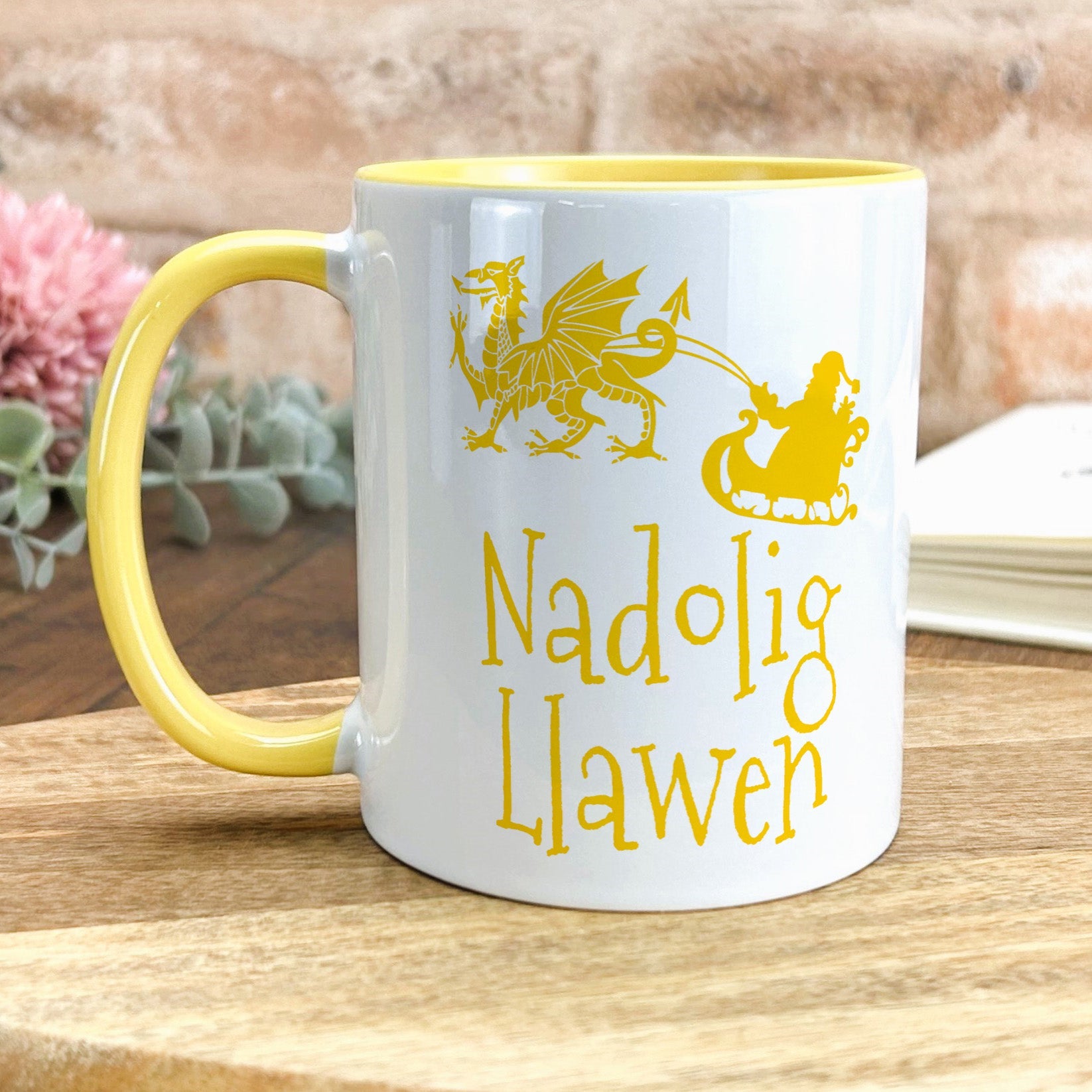 a yellow and white coffee mug sitting on top of a wooden table