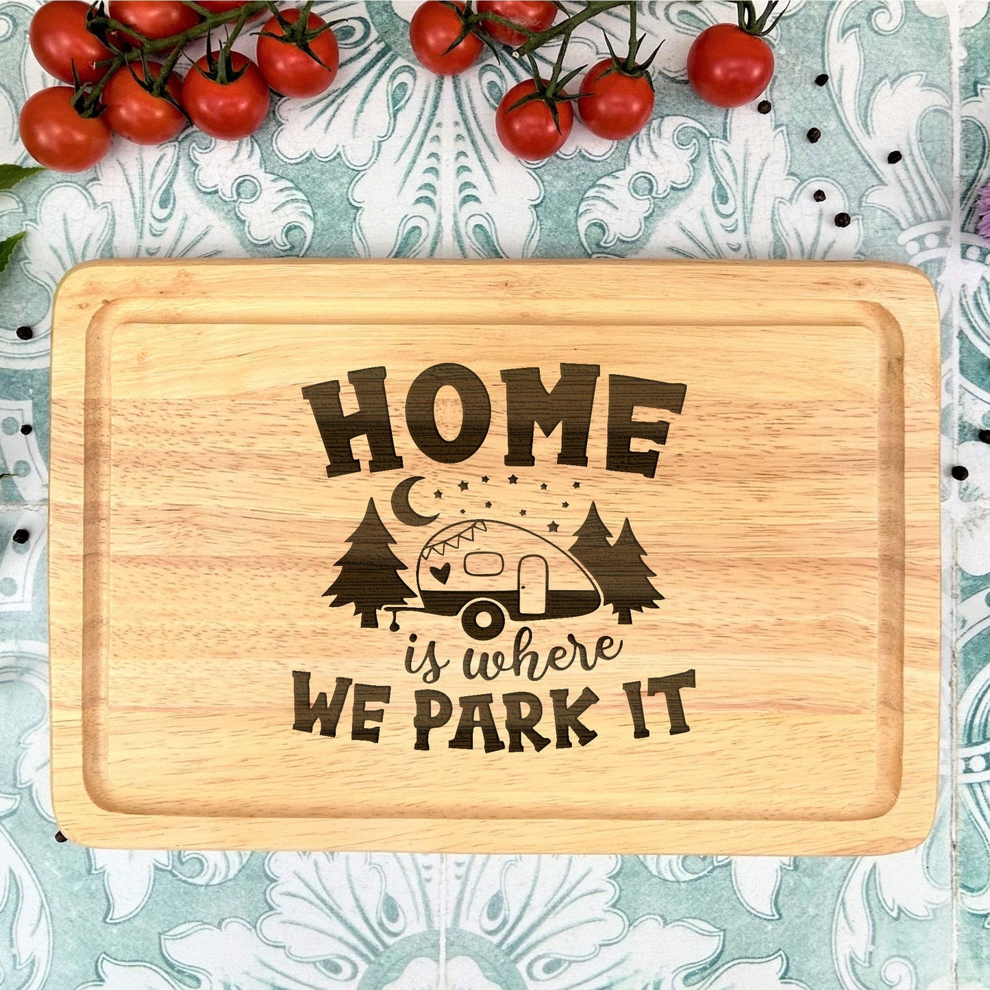 a cutting board with the words home is where we park it