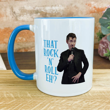a blue and white coffee mug with a picture of a man holding a microphone