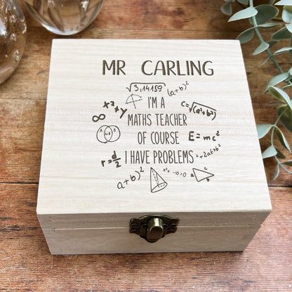 a wooden box sitting on top of a wooden table