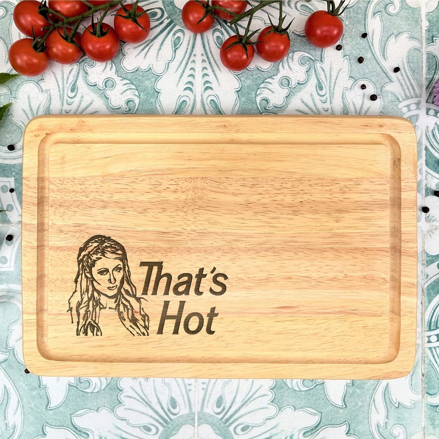 a cutting board with a picture of a woman and tomatoes