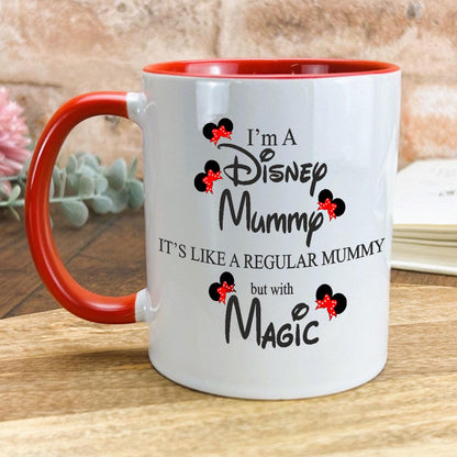 a red and white coffee mug sitting on top of a wooden table