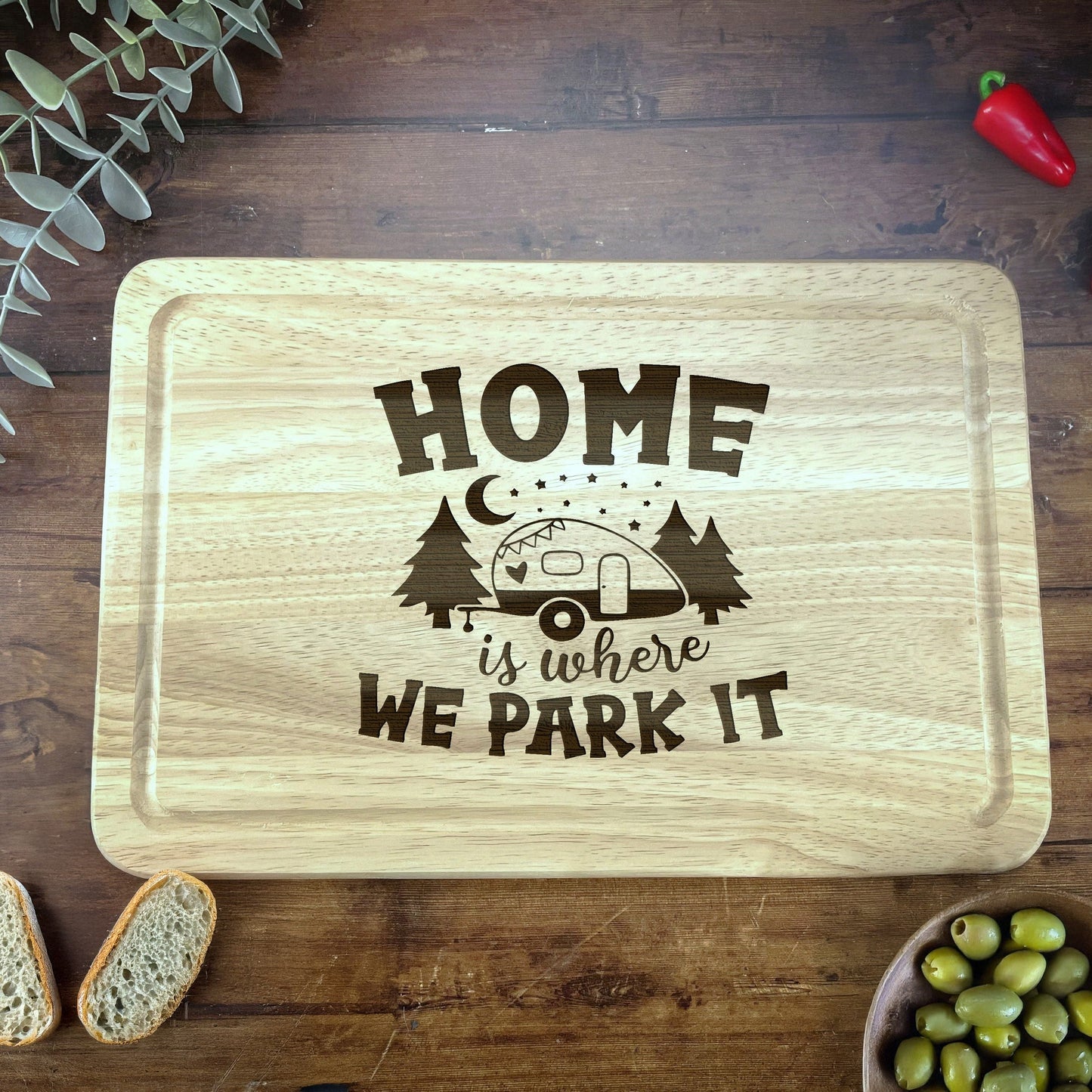 a cutting board that says home is where we park it