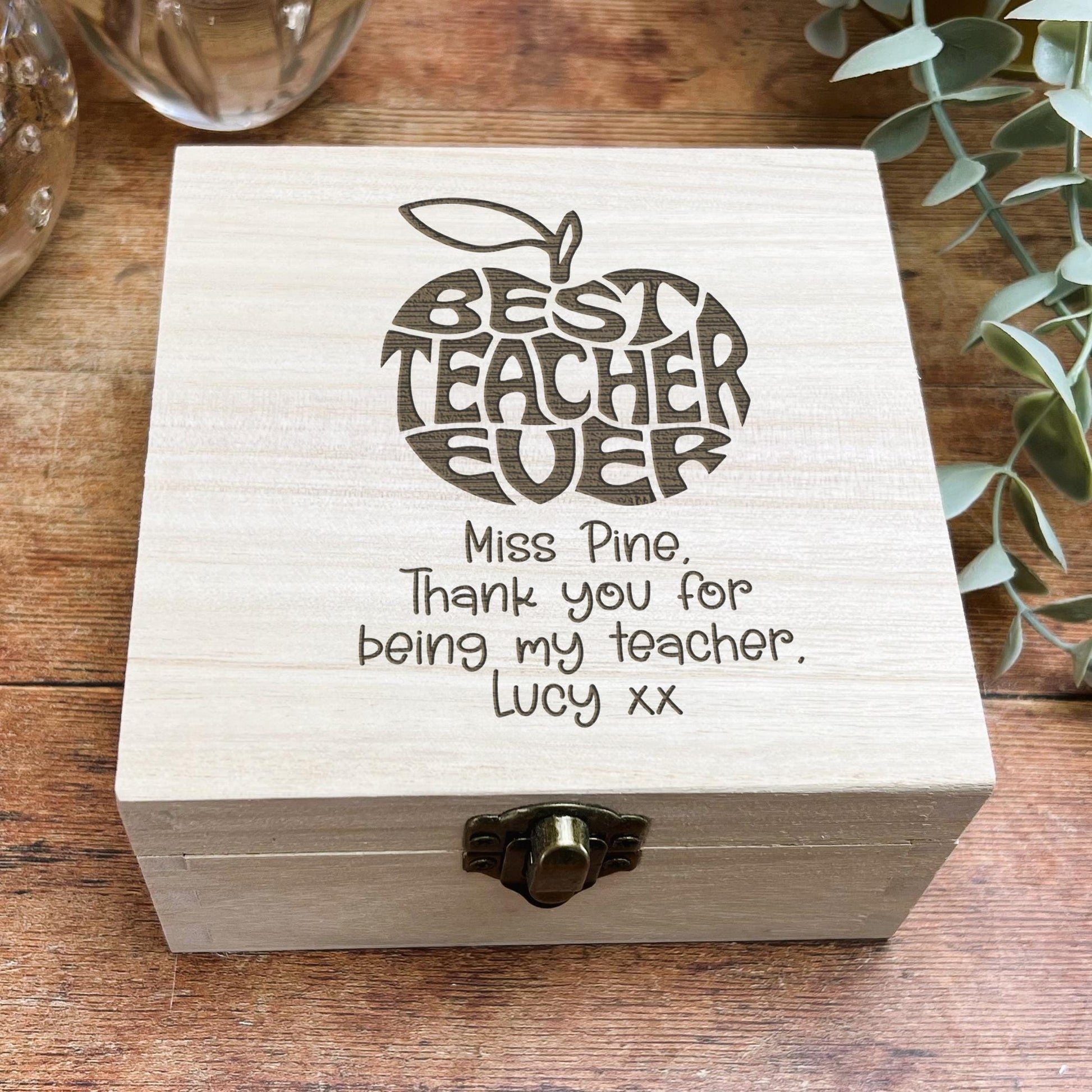 a wooden box with writing on it on a table