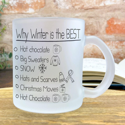 A white mug with text and illustrations on it, placed on a wooden surface.