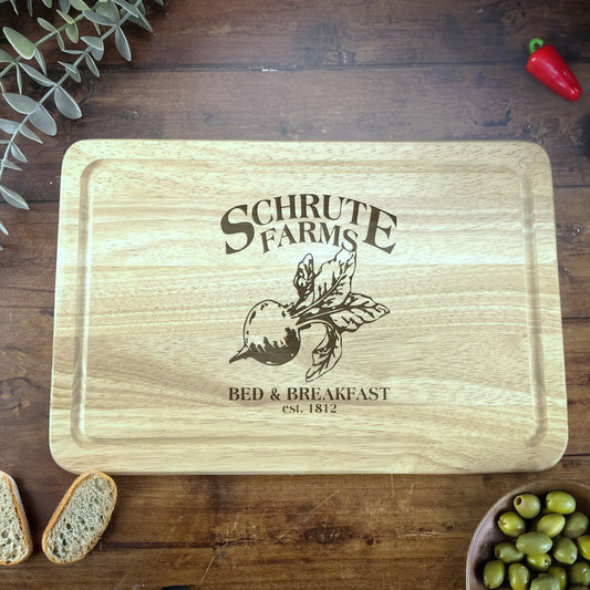 a wooden cutting board with a picture of a bear and a bowl of olives
