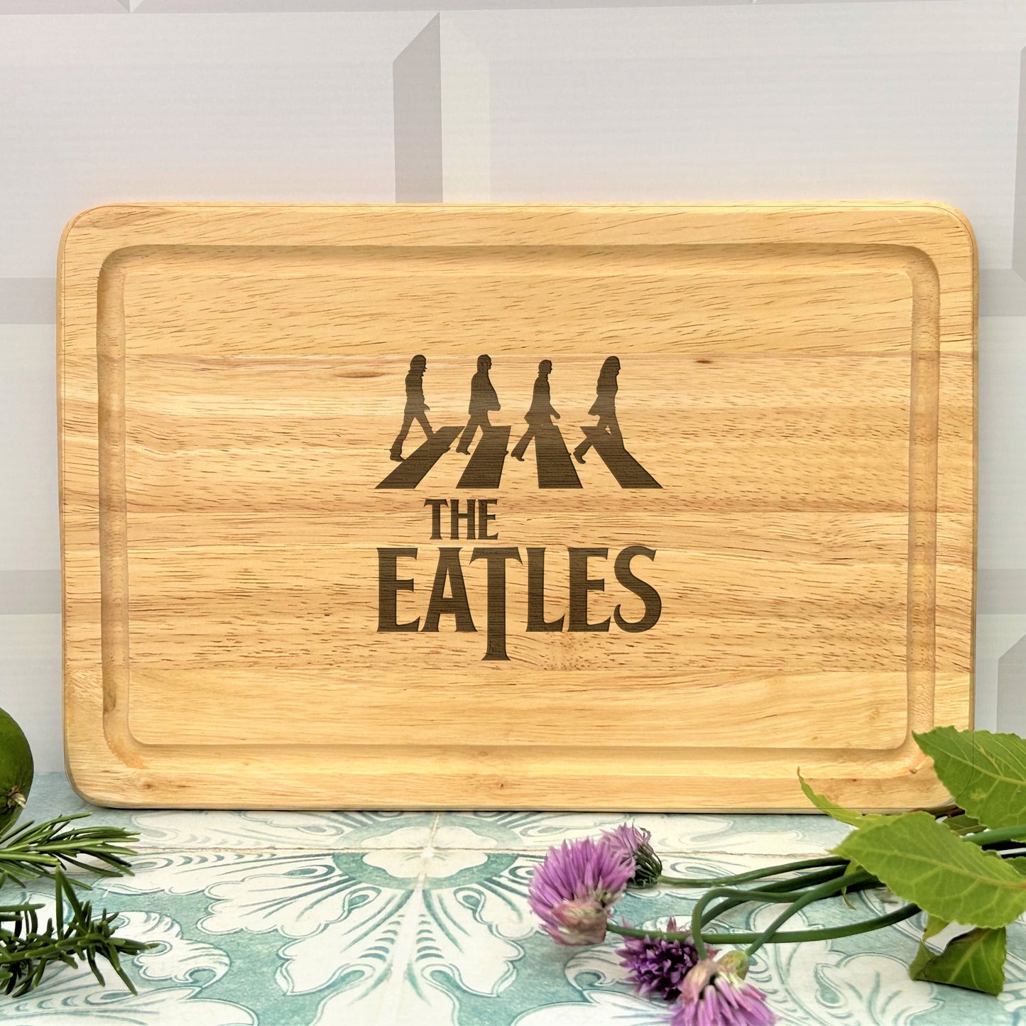 a wooden cutting board with the beatles on it
