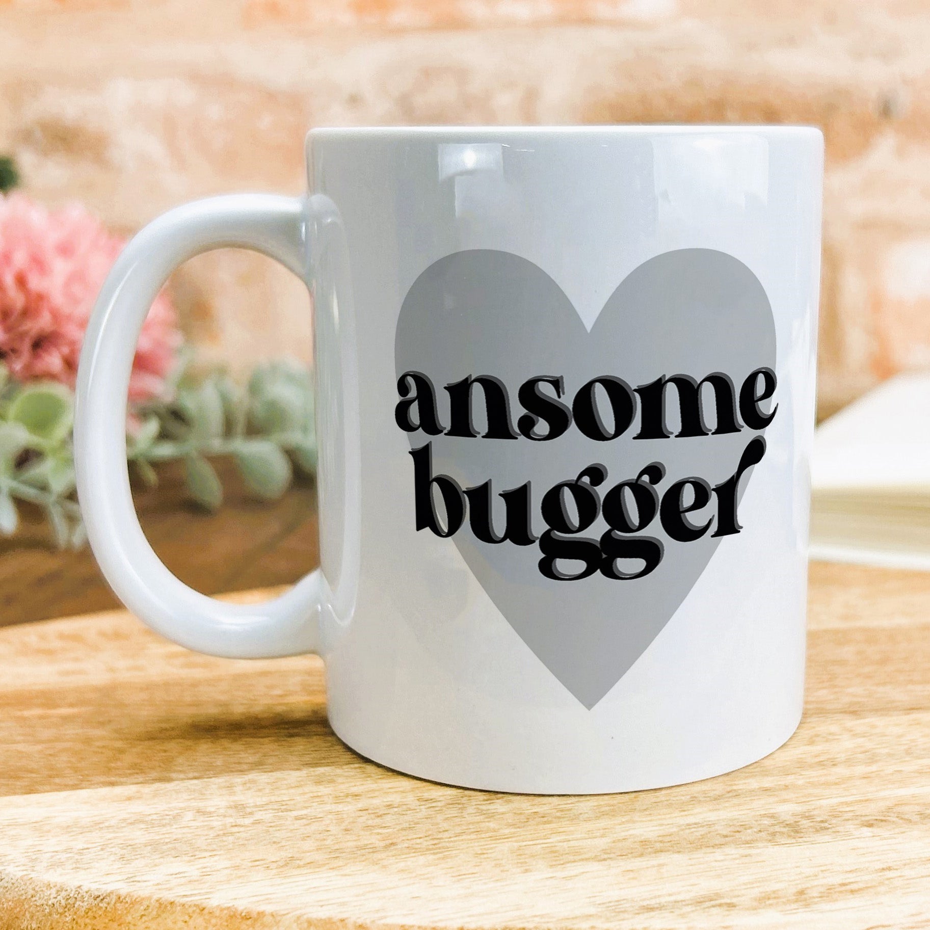 a white coffee mug with the words awesome bugger on it