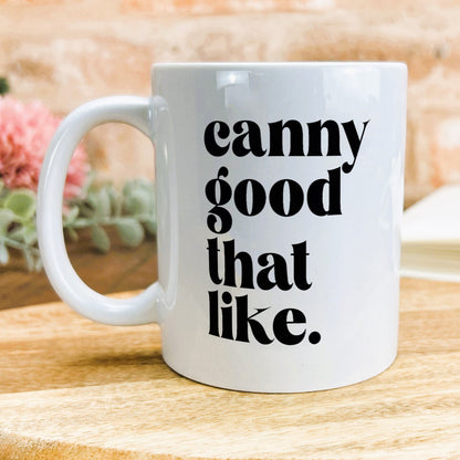 a white coffee mug sitting on top of a wooden table