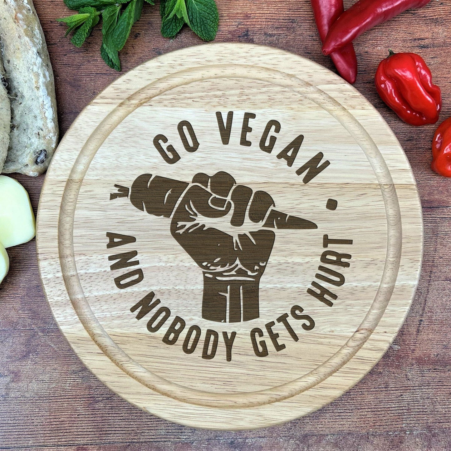 a wooden cutting board with a sign that says go vegan and nobody gets hurt