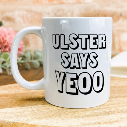 a white coffee mug with black lettering on it