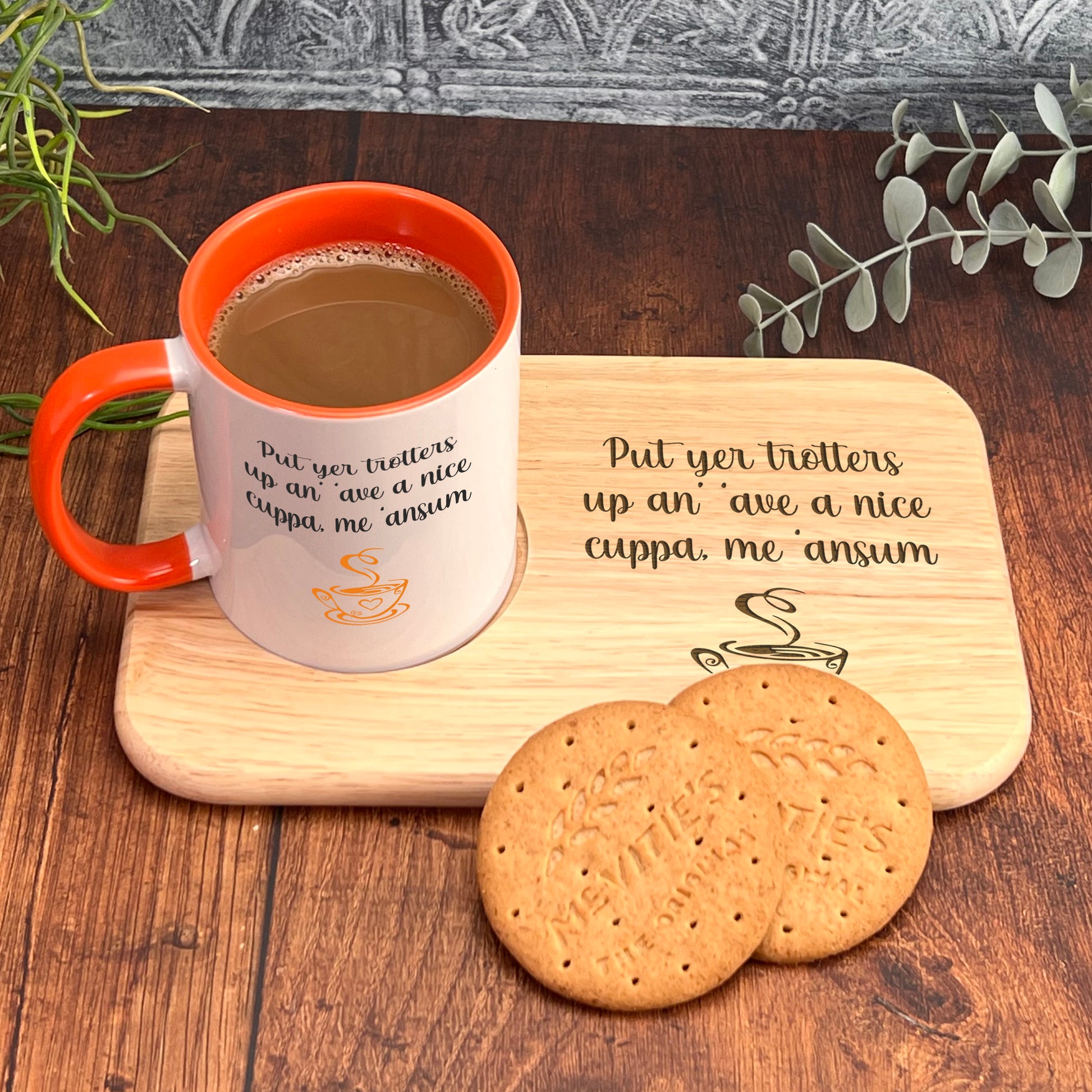 A wooden tray with a mug of coffee and two cookies, accompanied by a plant and a wooden plaque with a humorous message.