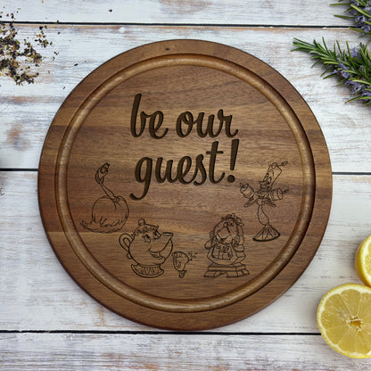 a wooden sign that says, be our guest