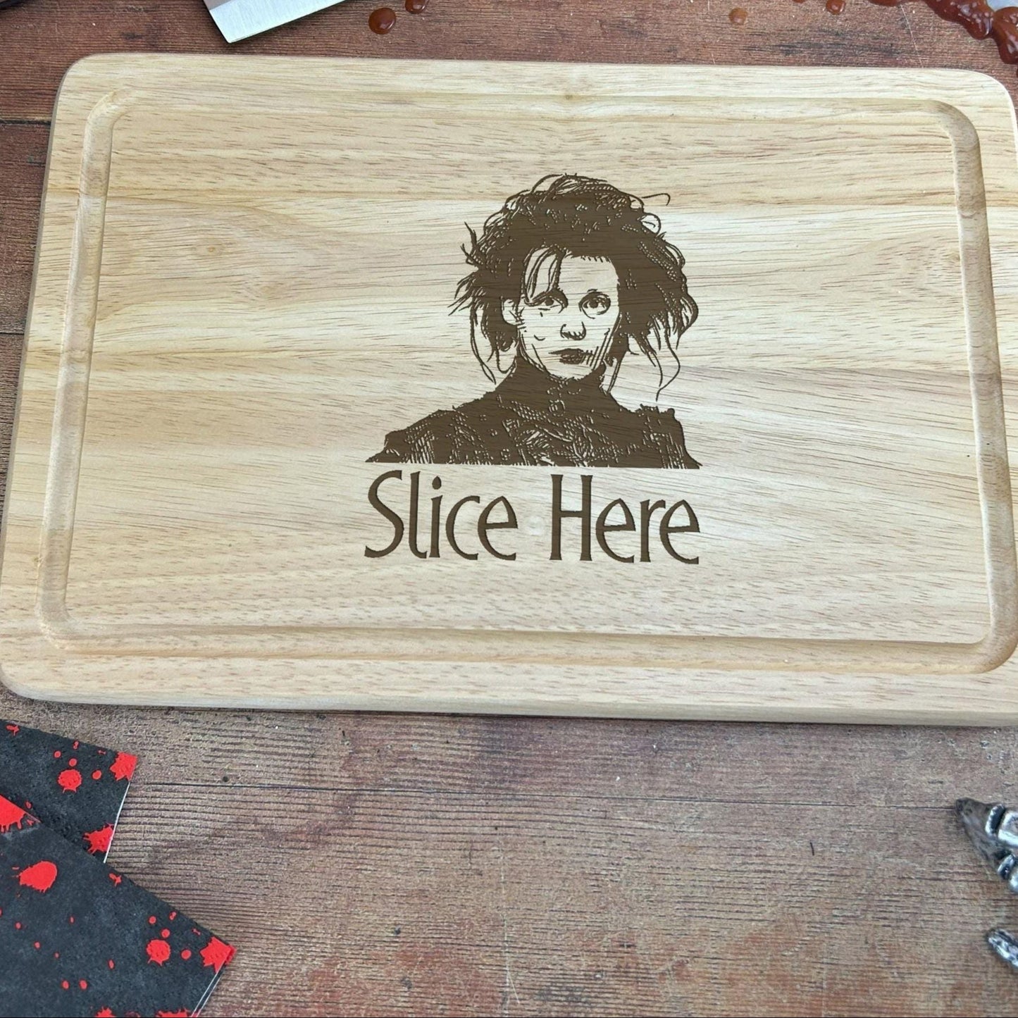 a wooden cutting board with a picture of a person on it