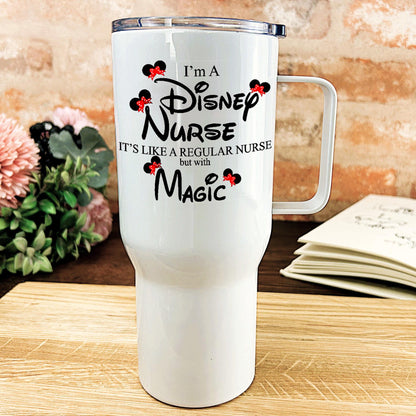 a white travel mug sitting on top of a wooden table