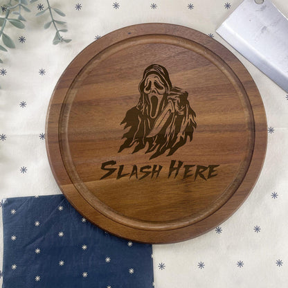a wooden cutting board with a picture of a ghost on it