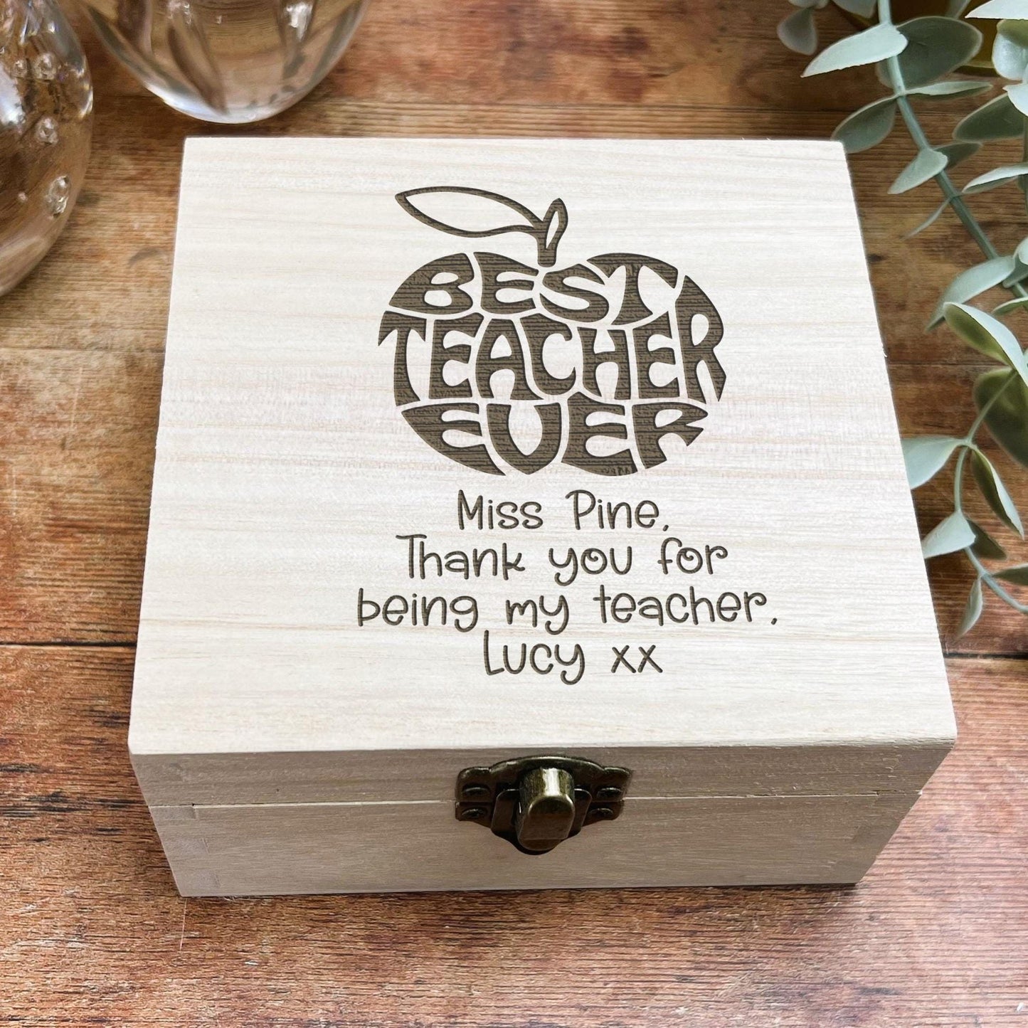a wooden box with writing on it sitting on a table
