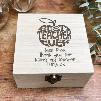 a wooden box with writing on it sitting on a table